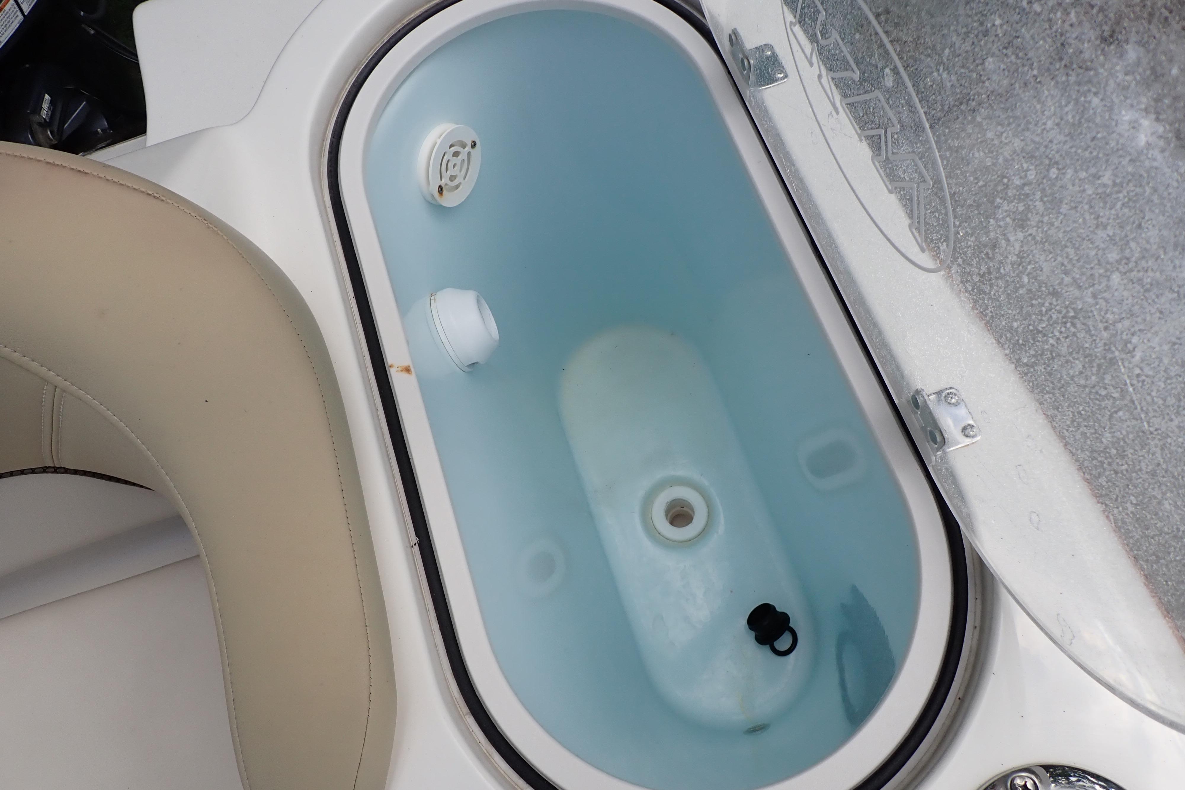 2019 Key West 263 FS boat livewell with open lid and water inside.