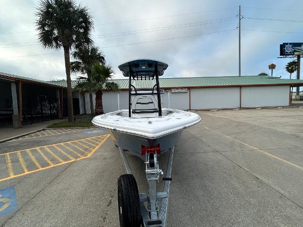 2024 Sea Pro 250 DLX boat on trailer in parking lot, palm trees in background.