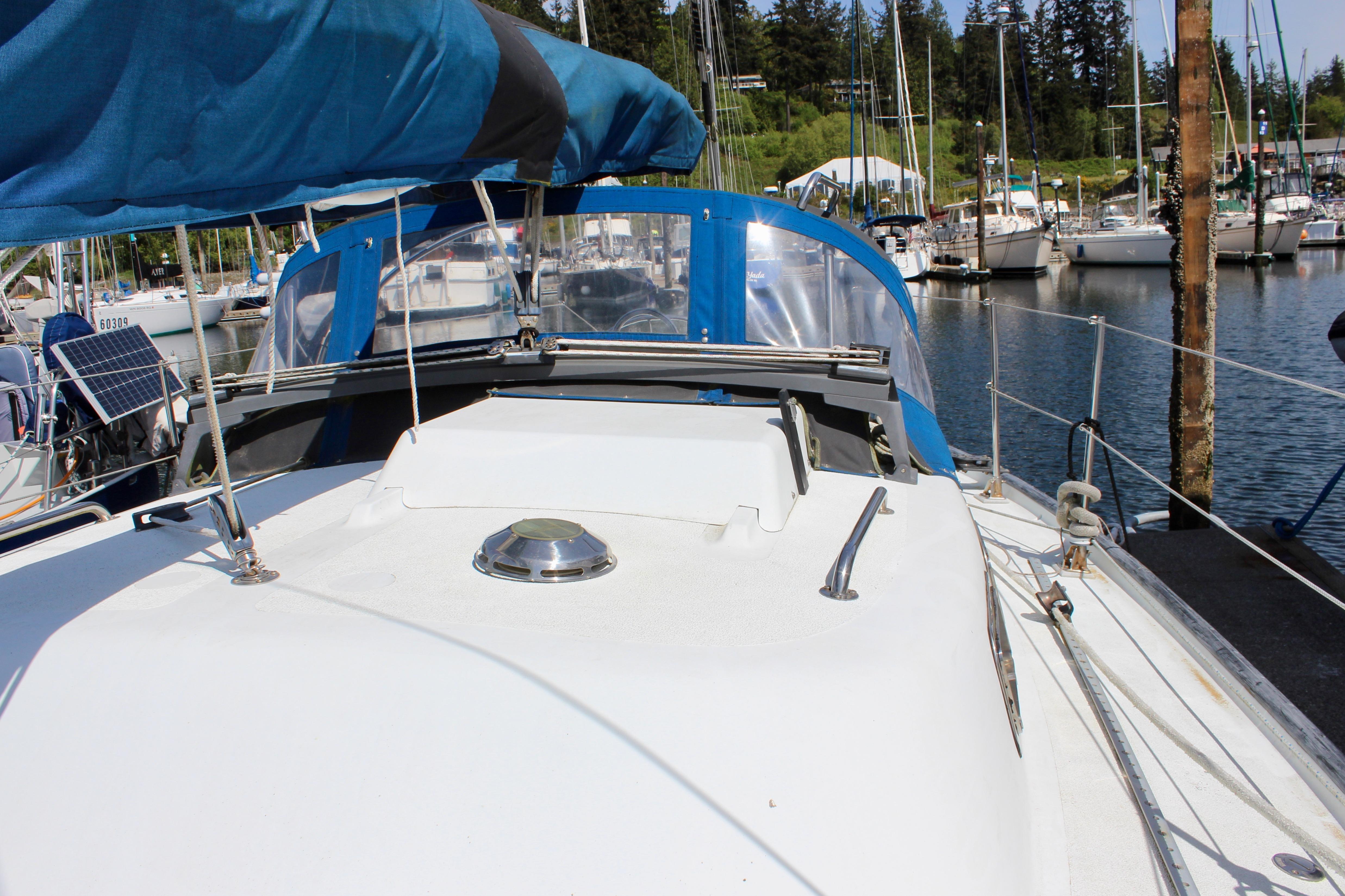 Sailboat Freya 39, 1993 model, docked at marina with blue canopy and clear skies.