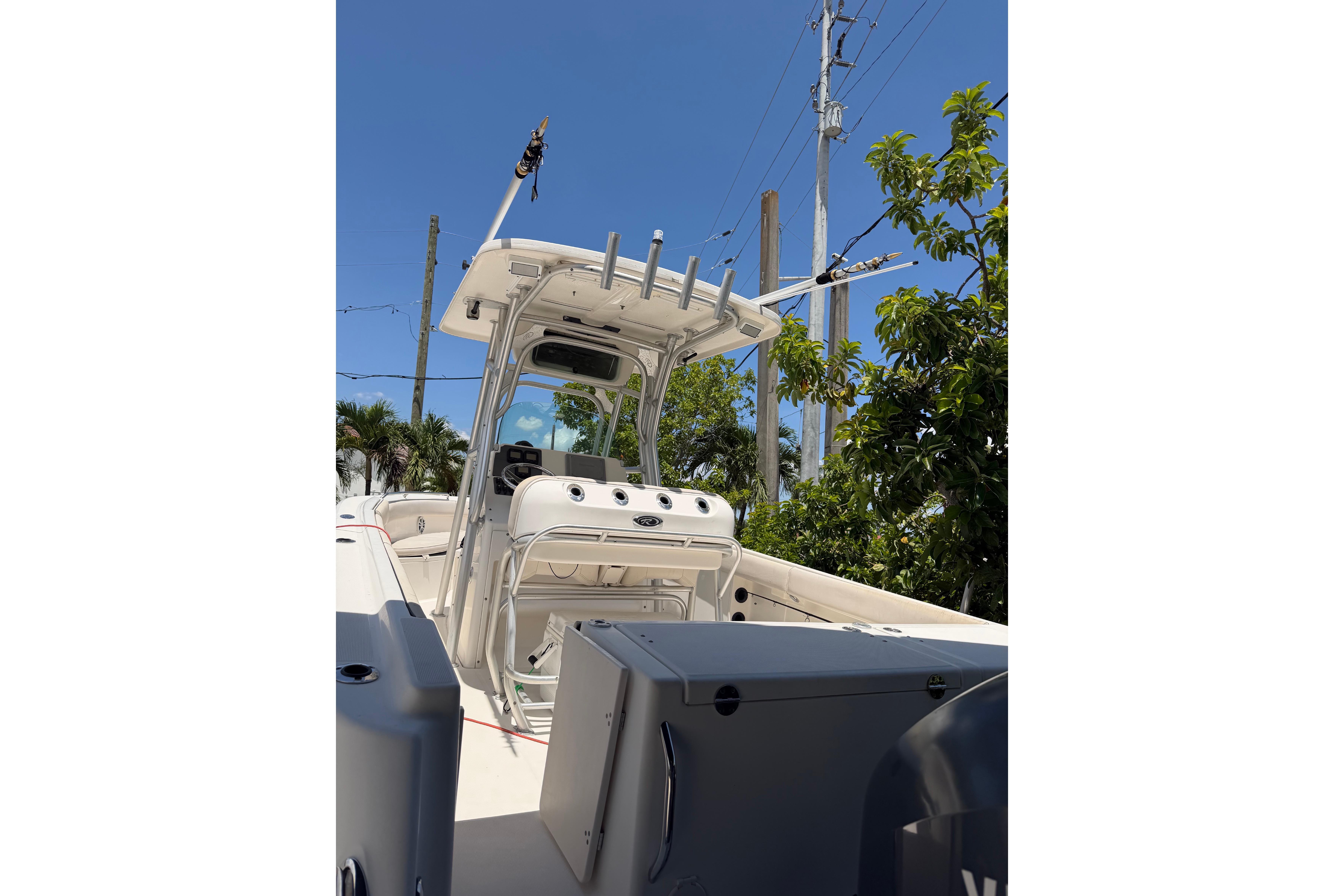 2007 Robalo R260 Center Console boat with T-top and fishing rod holders.