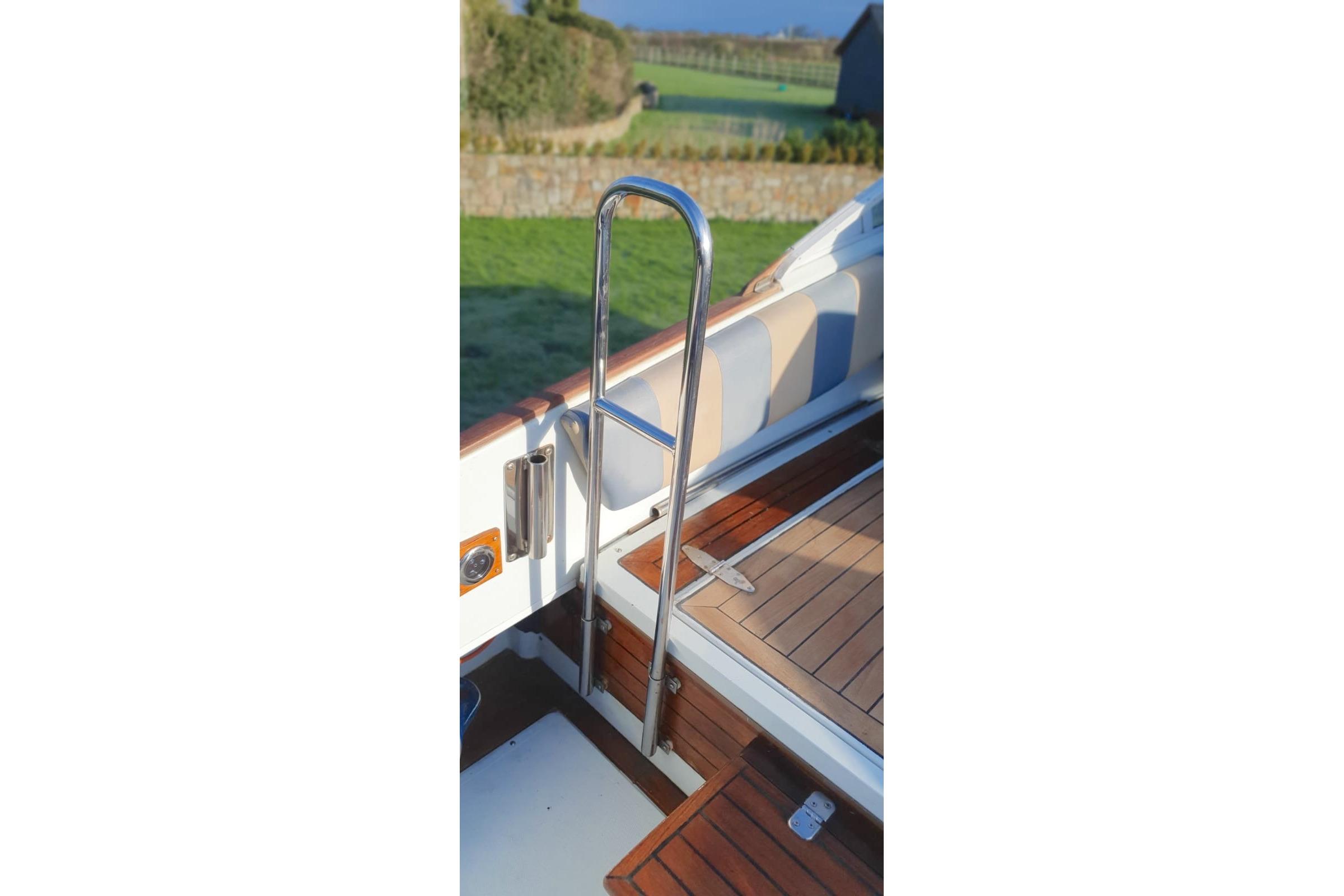 Chrome railing on Fairey Spearfish MKIII boat, 1989 model, with wooden deck.
