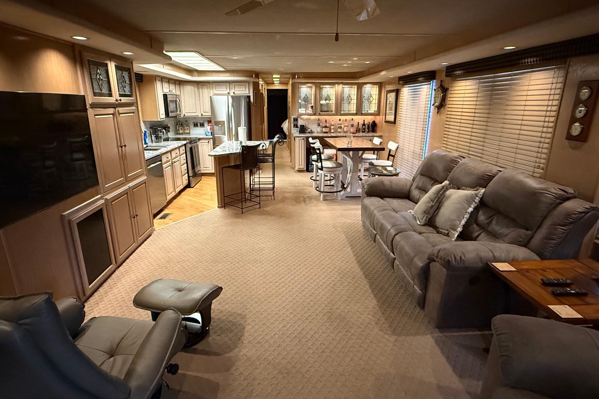 Luxurious 1998 Sumerset 16x76 houseboat interior with modern kitchen and cozy living area.