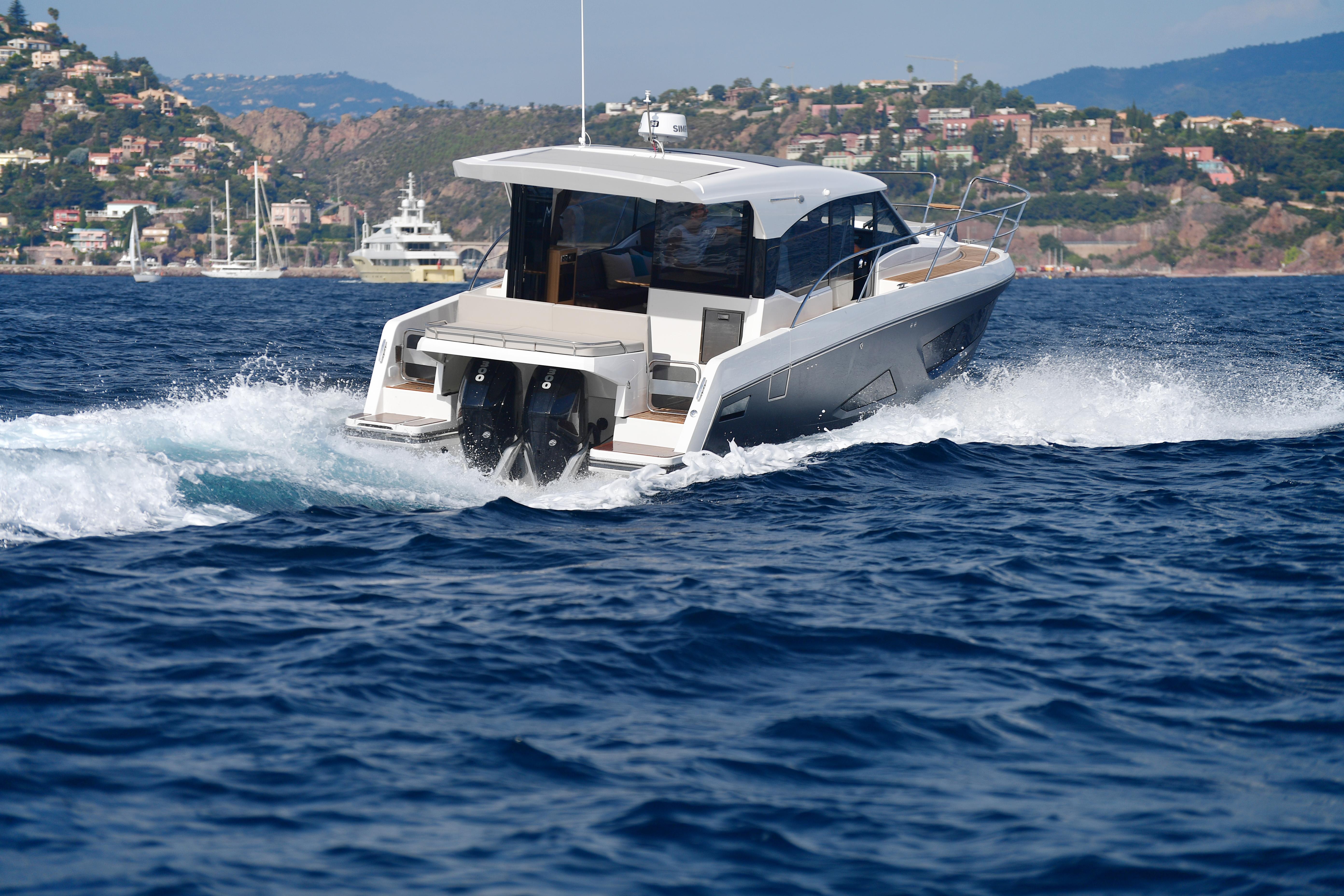 2025 Skamander Monaco Coupe cruising on blue ocean waters near scenic coastline.