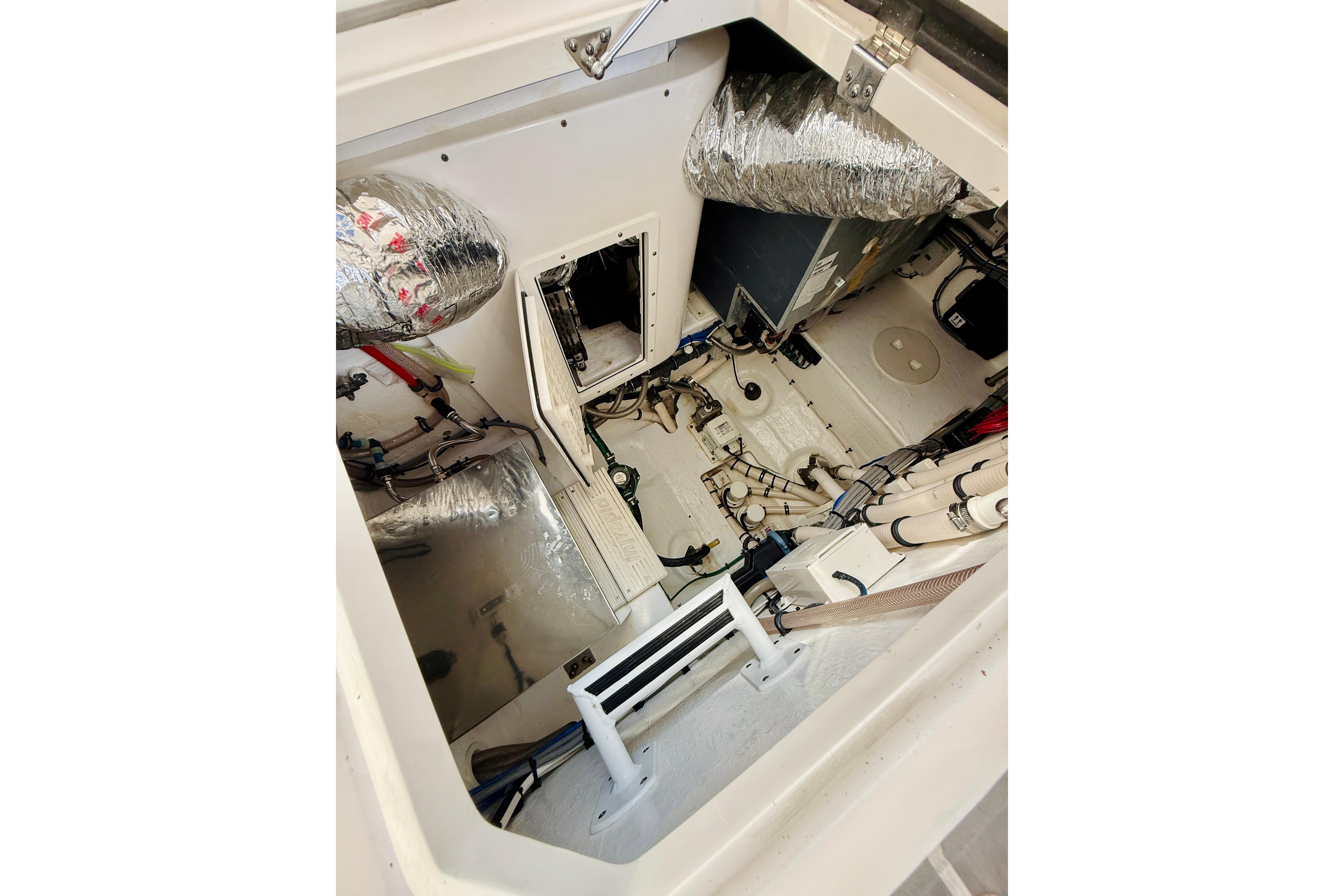 Engine compartment of 2021 Intrepid 410 Evolution boat, showcasing mechanical components and insulation.
