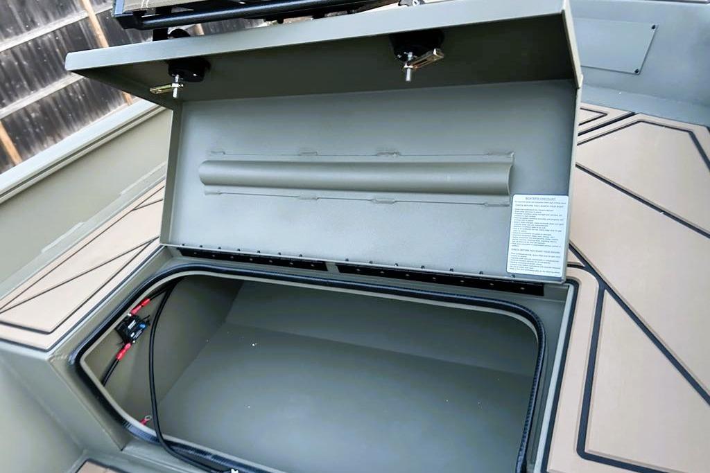 Open storage compartment in 2026 Tracker Grizzly 1650 T Prairie Wings Edition boat.