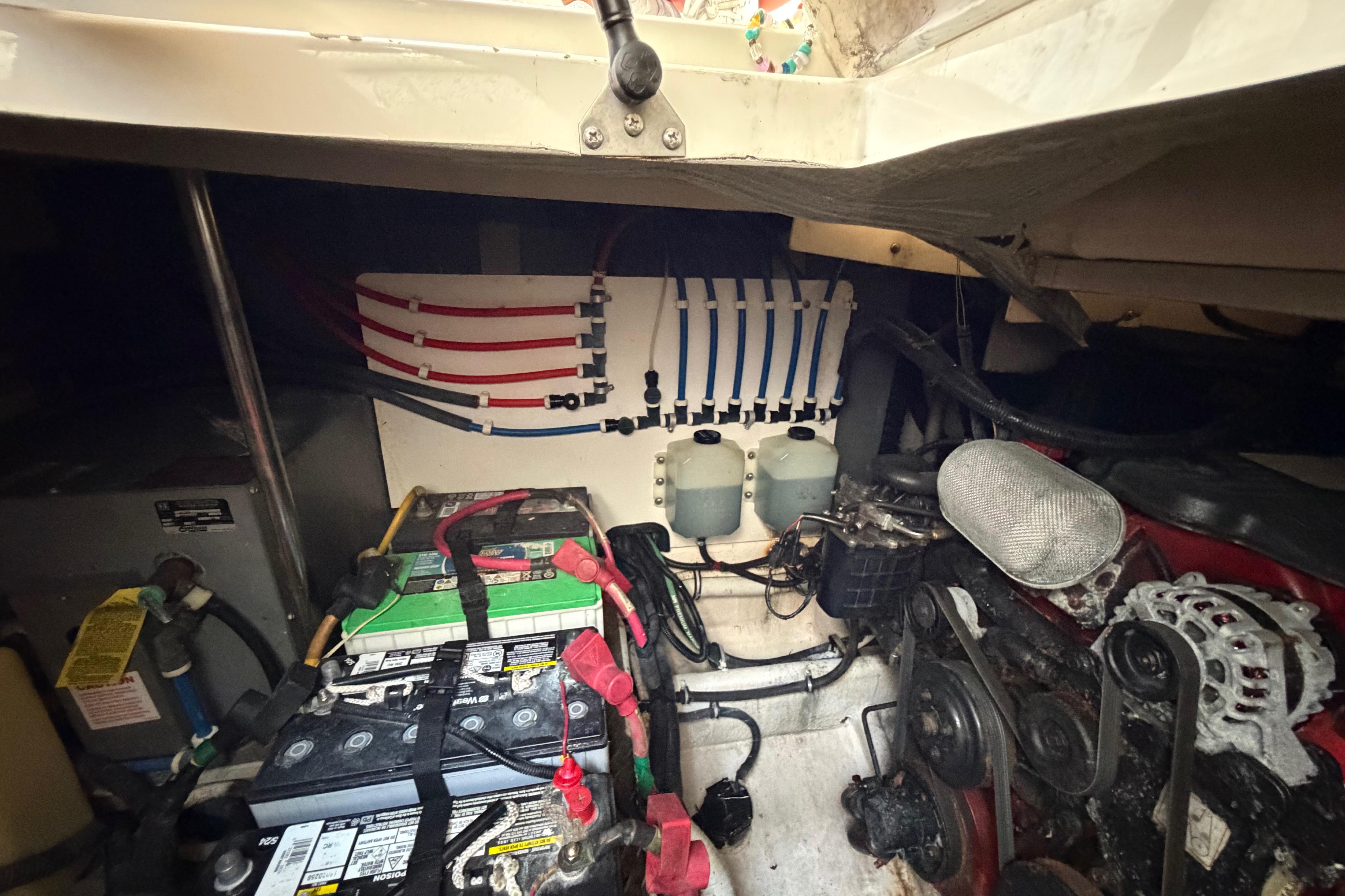 Engine compartment of a 2007 Monterey 350 Sport Yacht, showing batteries and wiring.