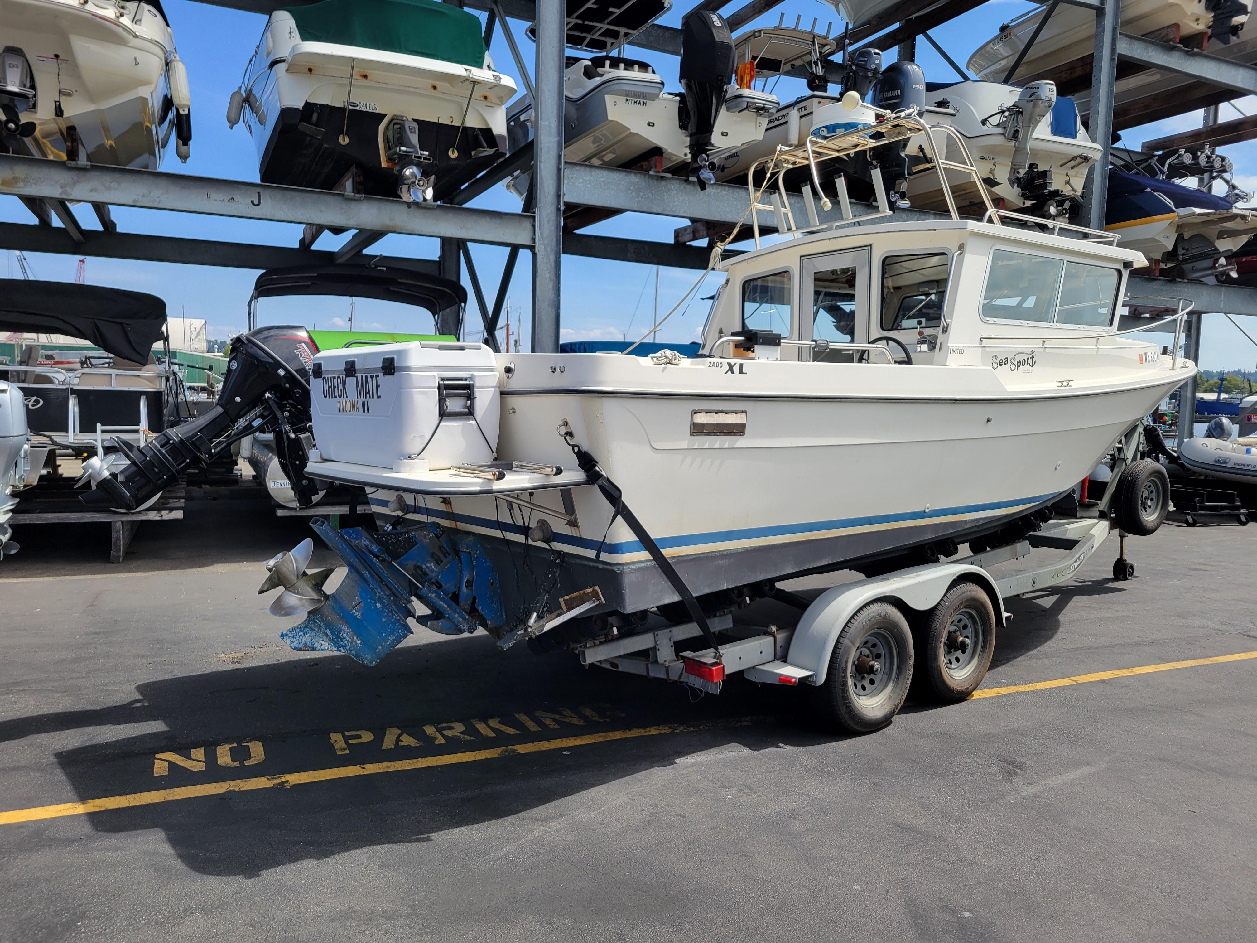 1999 SeaSport 2400 XL Limited boat on trailer in marina storage area.