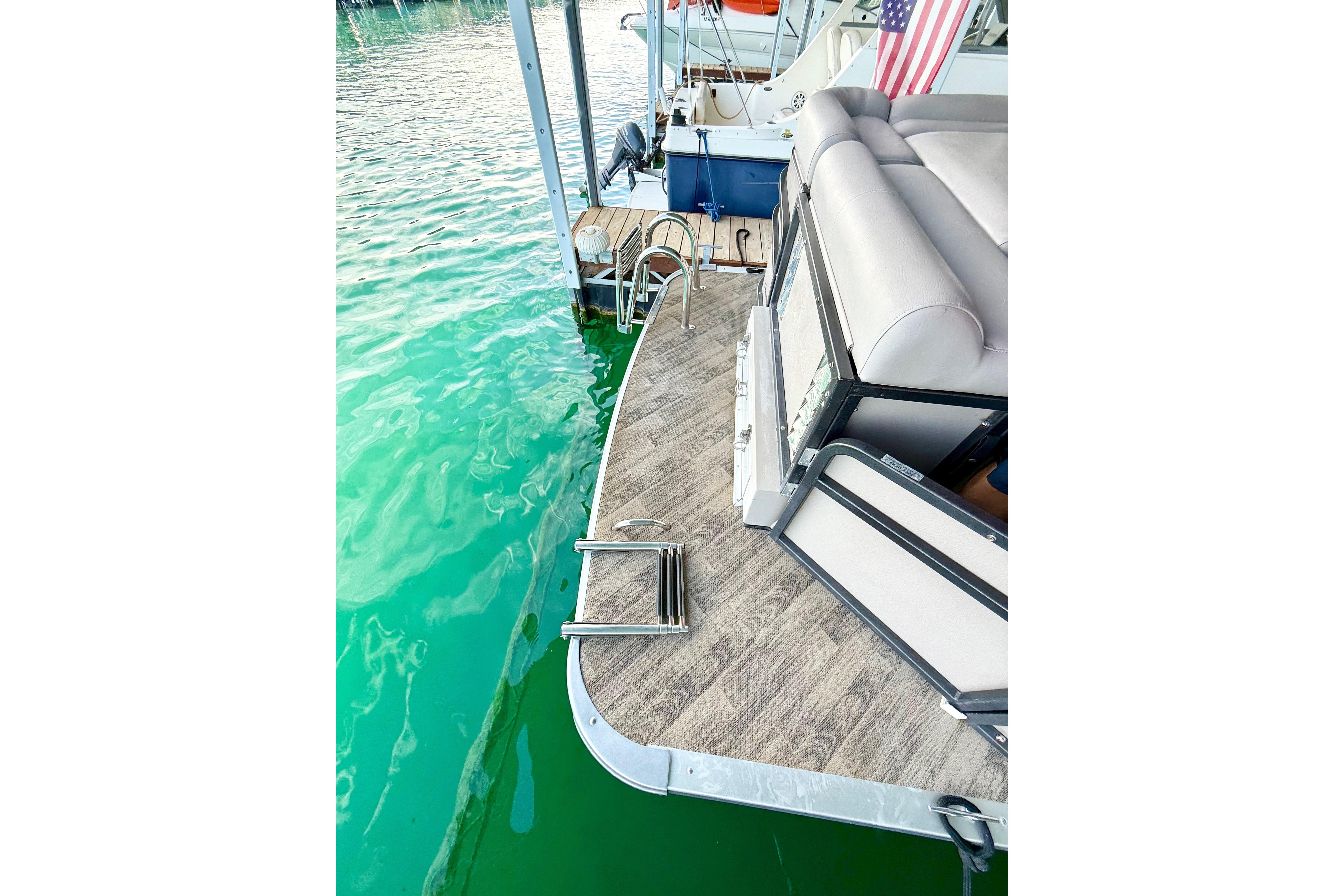 Premier 275 Grand Majestic PTX 2011 pontoon boat with swim ladder on turquoise water.