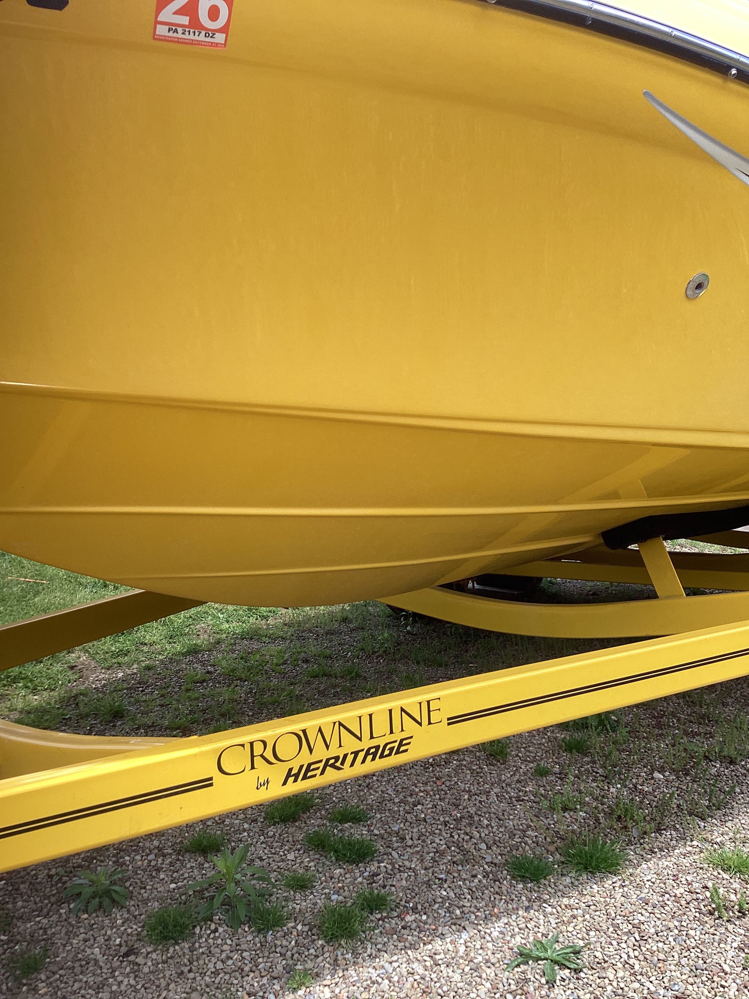 Yellow 2005 Crownline 202 BR LPX boat on trailer.