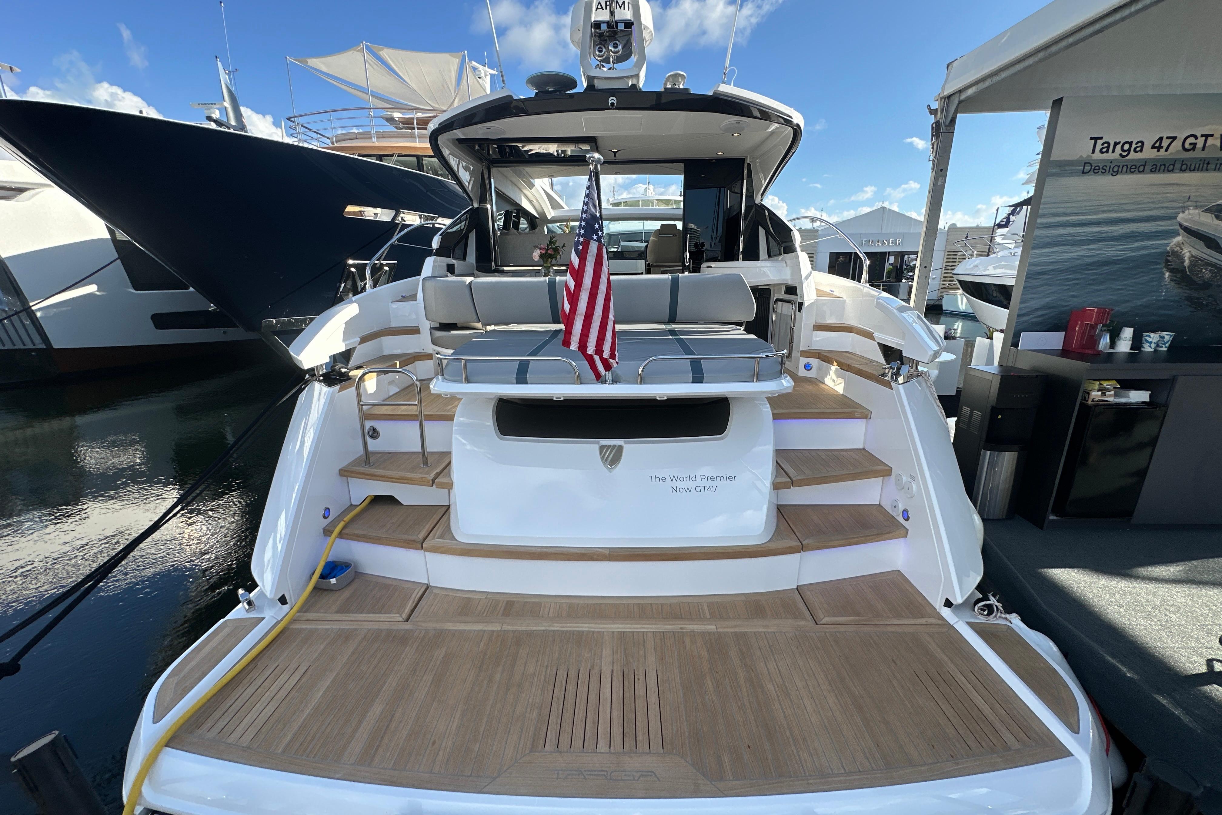 Fairline Targa 47 GT 2026 yacht with American flag, docked at marina.