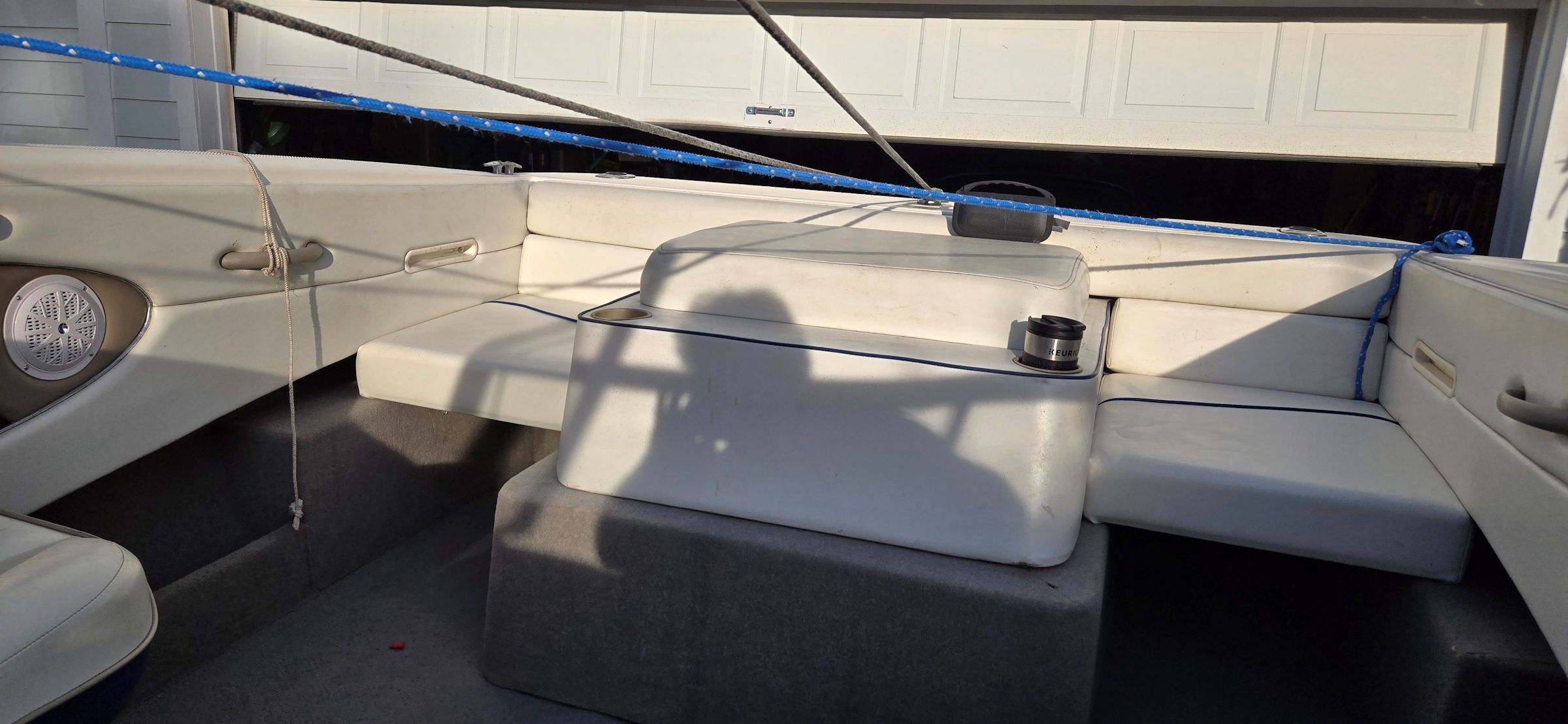Interior of a 2004 Bayliner B210 Classic boat with white seating.