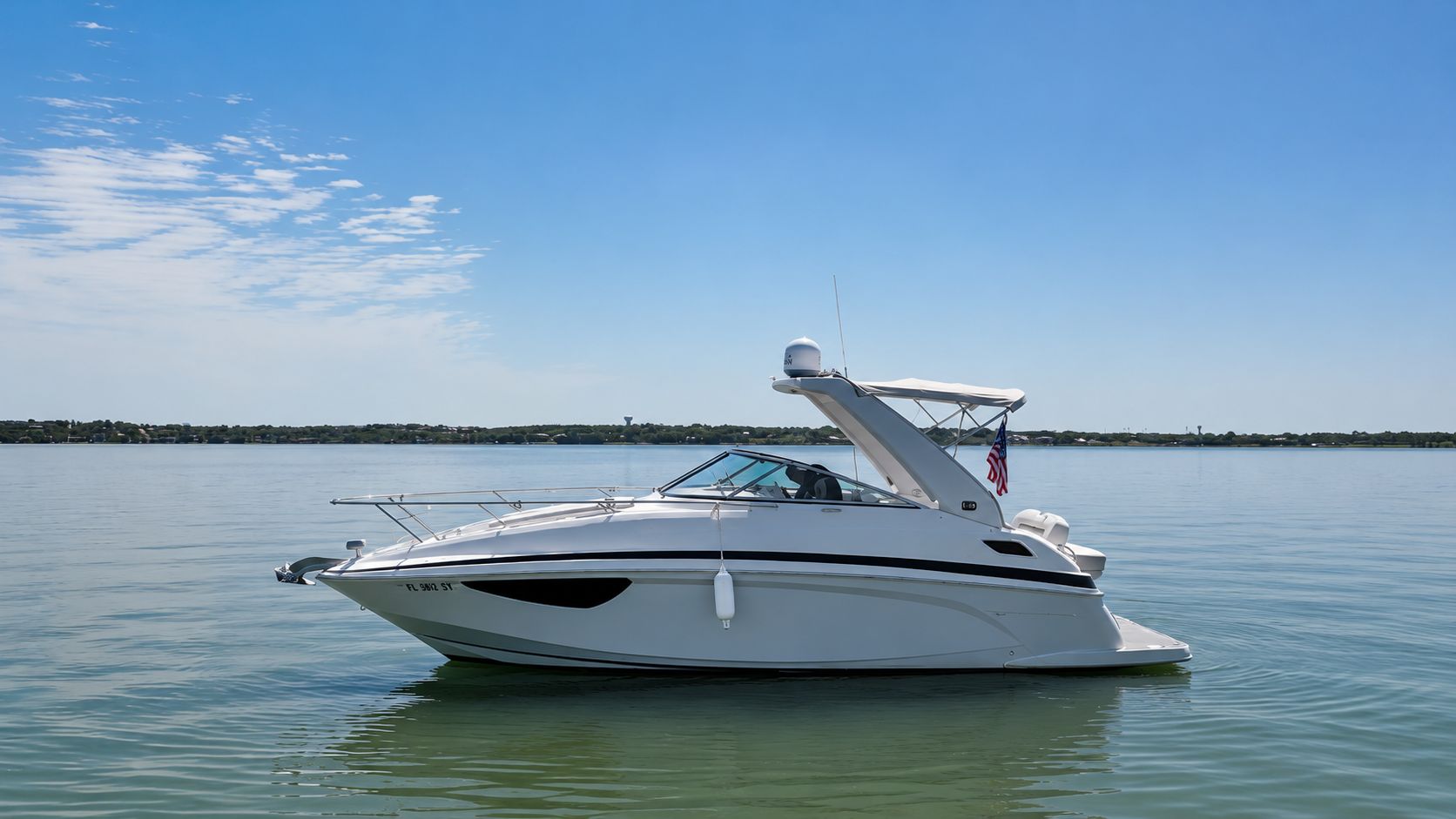 A 2020 Regal 28 Express boat on calm water under a blue sky.