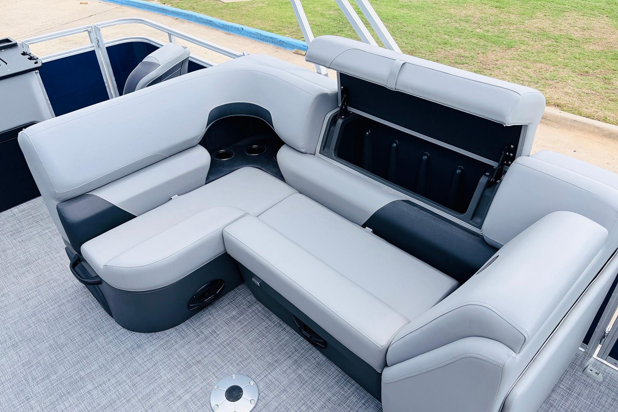 2026 Sun Tracker SportFish 22 DLX boat interior with gray seating and storage compartment.