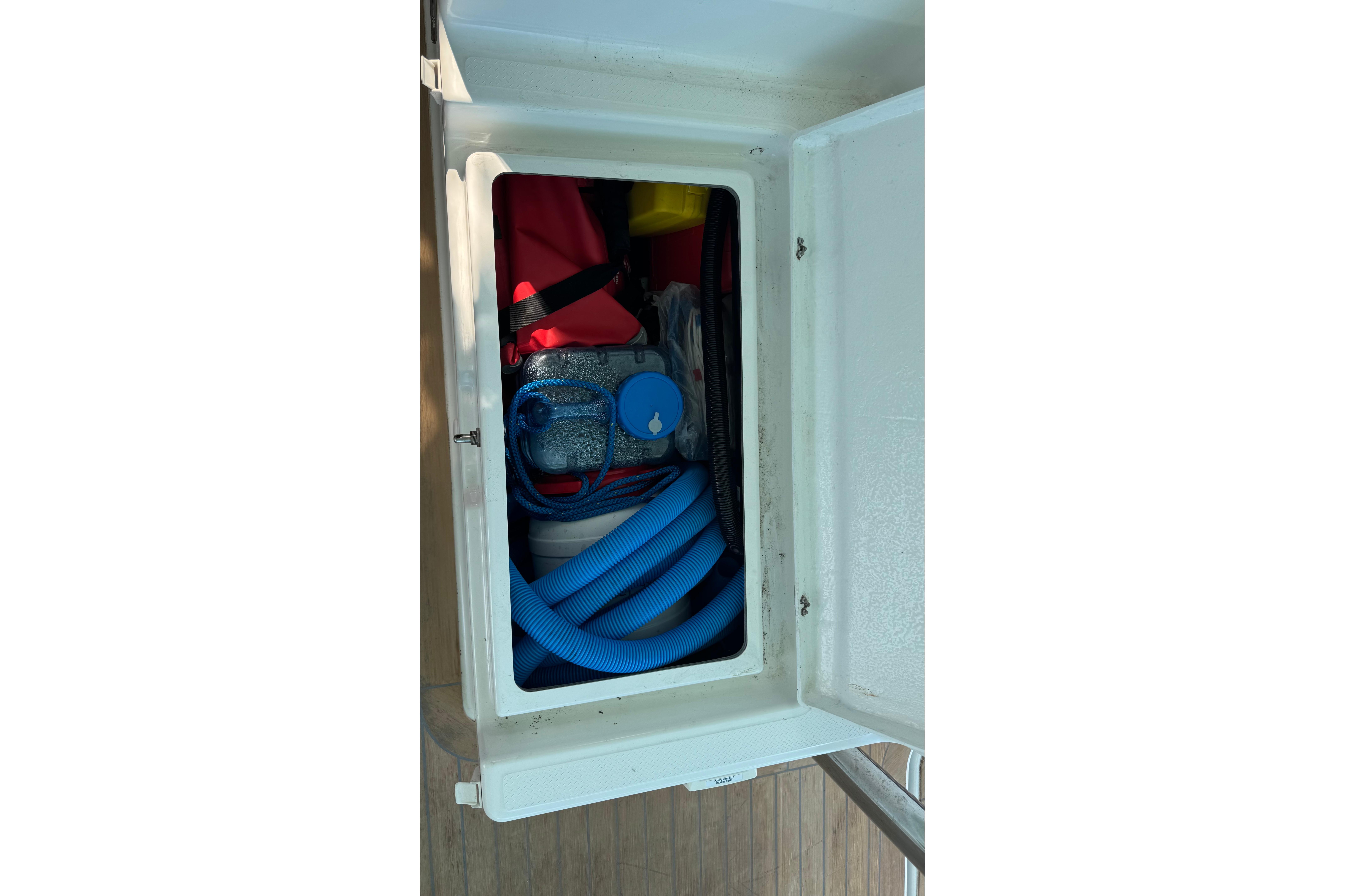 Storage compartment on 2020 Fountaine Pajot Saona 47 yacht with hoses and equipment.