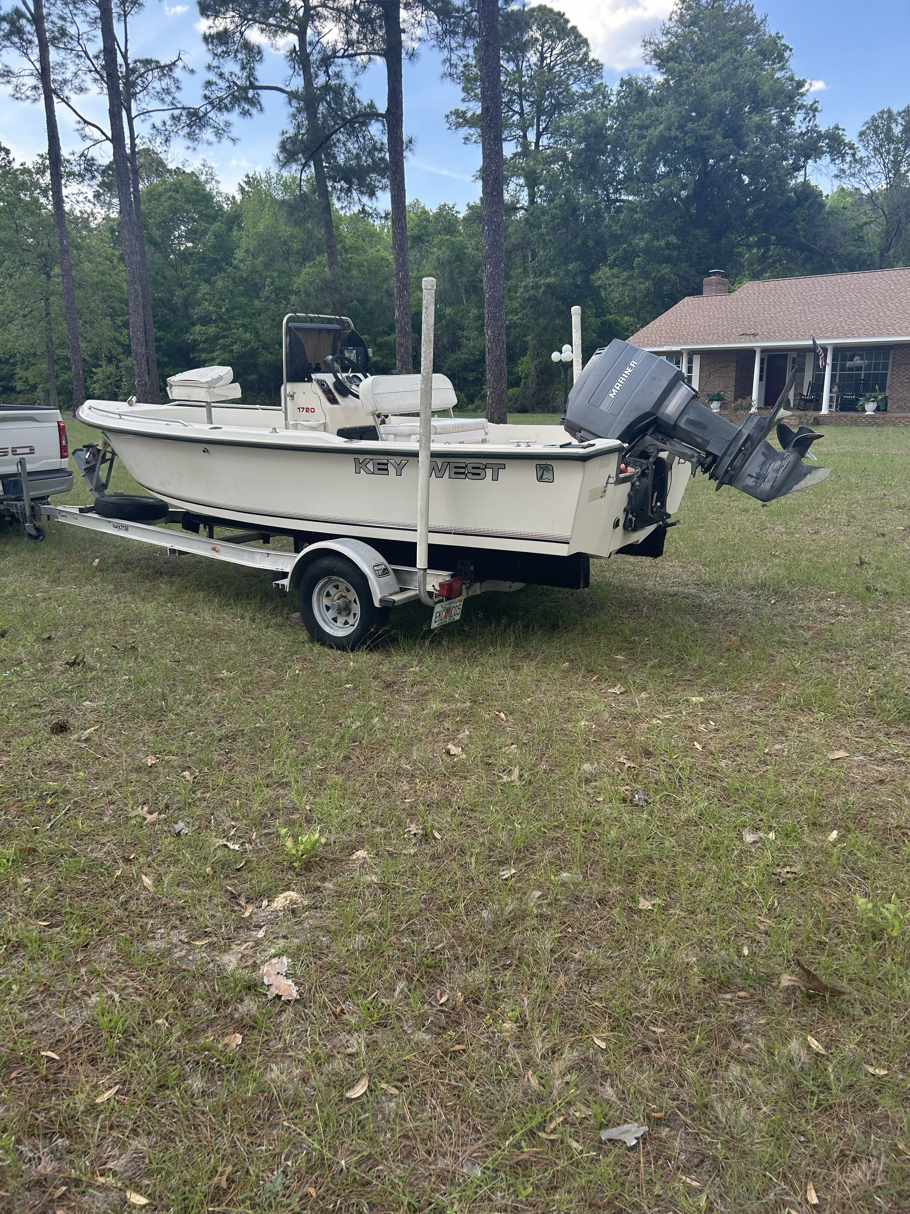 1993 Key West 1720 boat on trailer outdoors.