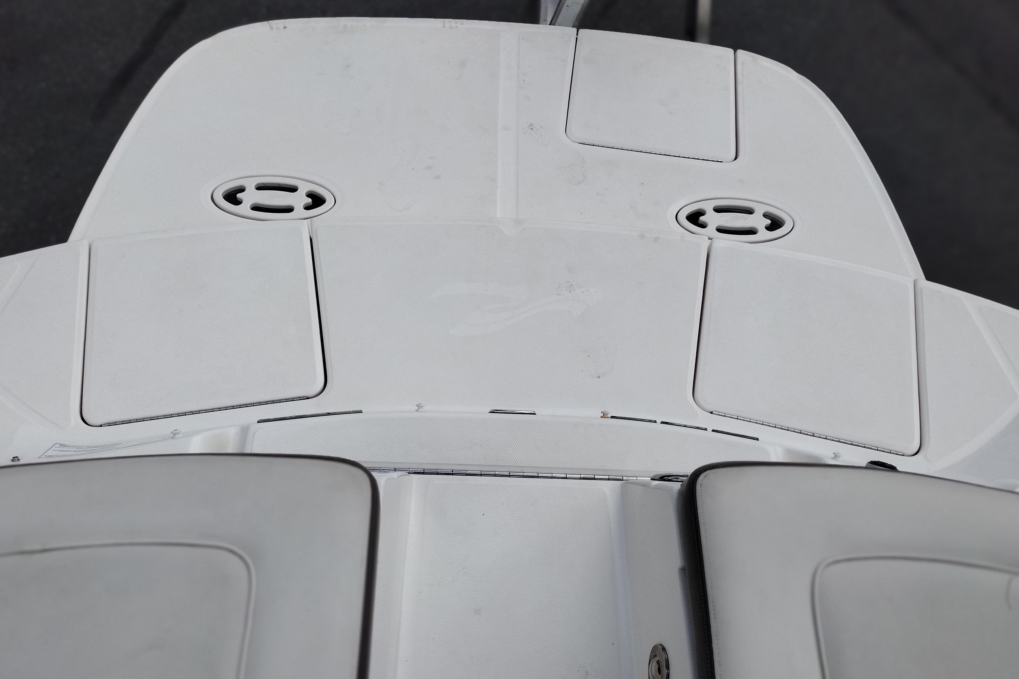 Rear deck of a 2013 Sea Ray 300 SLX boat, featuring storage compartments.