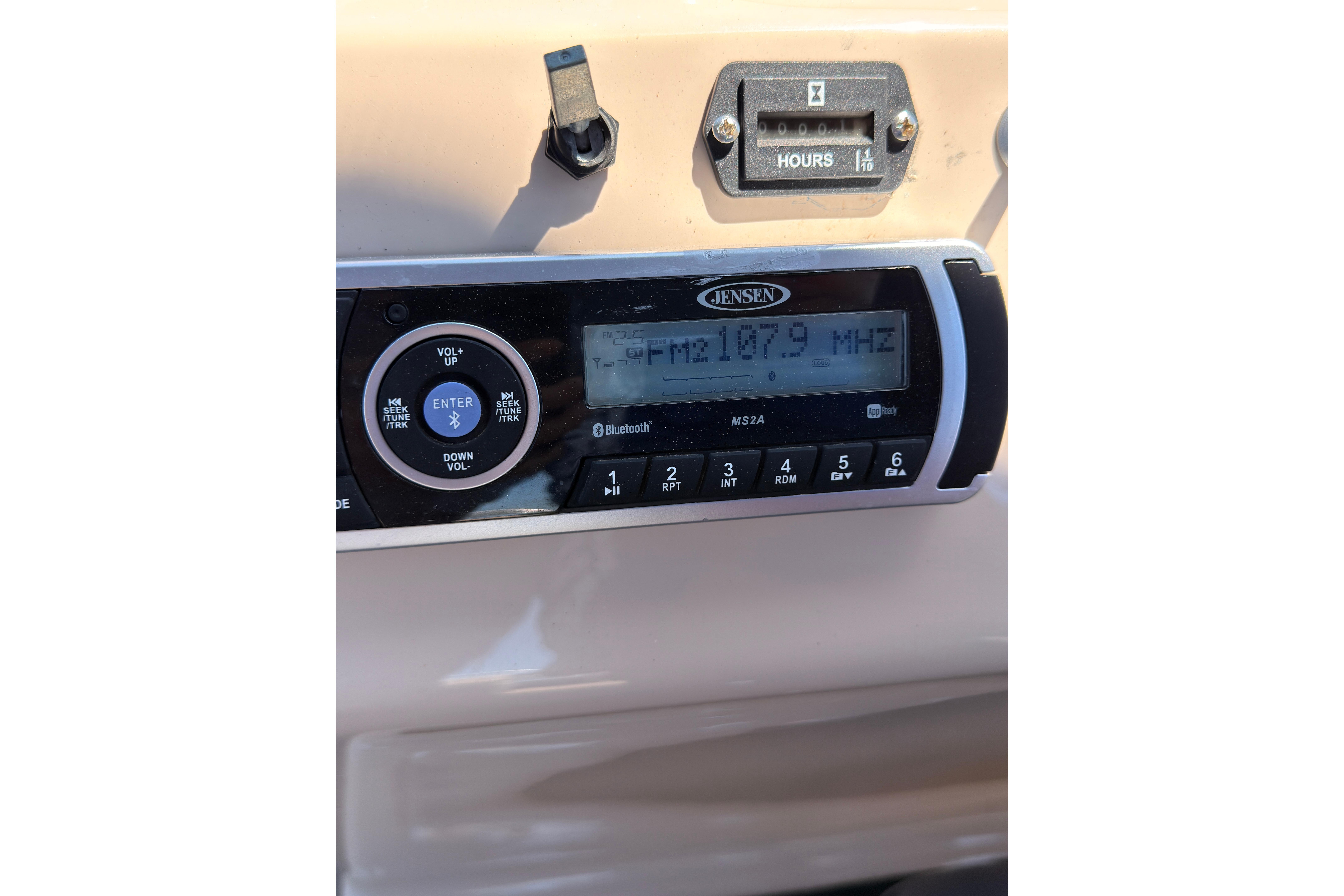 Jensen radio display on 2019 SUNTRACKER Party Barge 20 DLX, tuned to FM 107.9 MHz.
