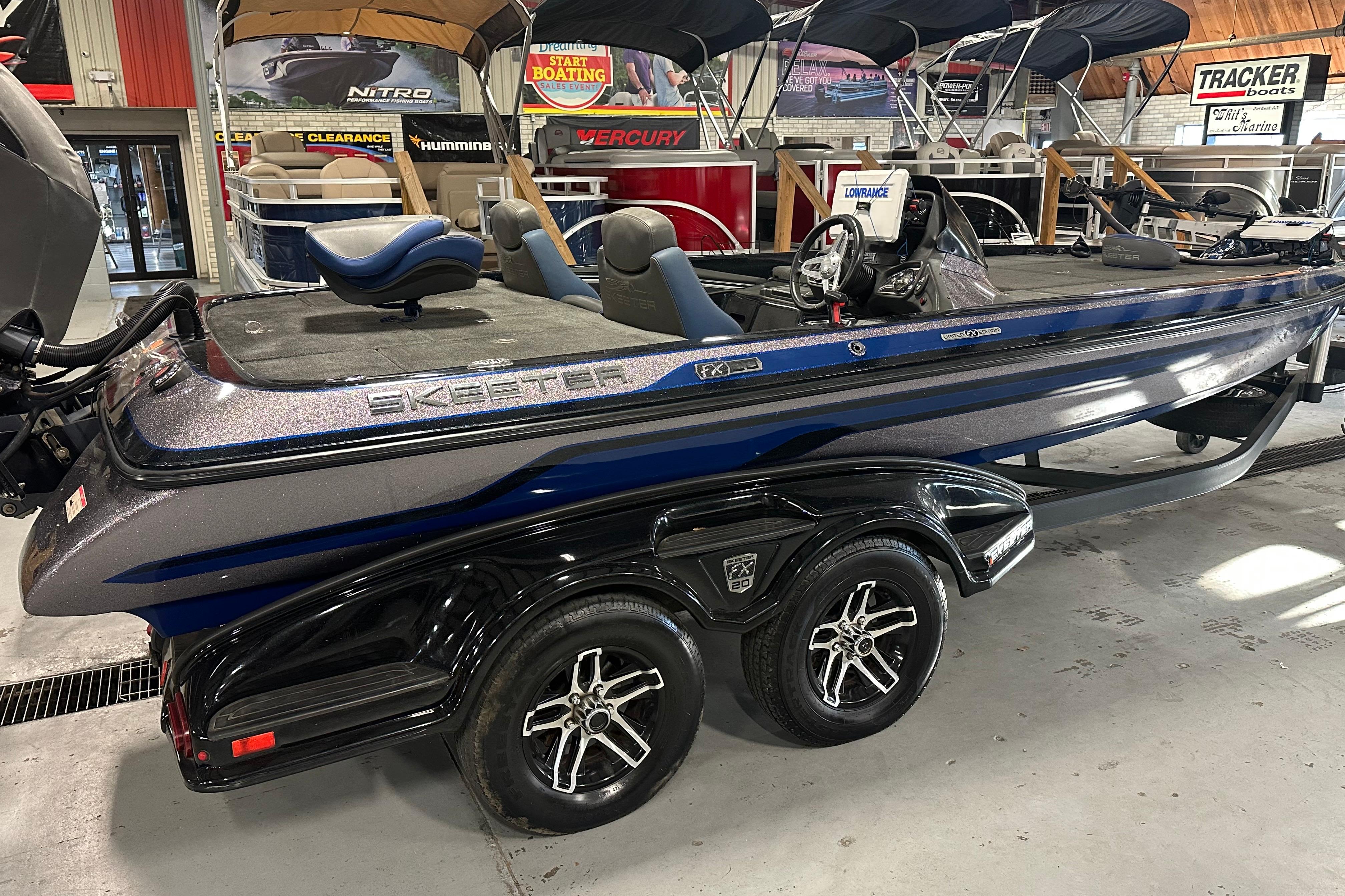 2016 Skeeter FX20 Limited Edition boat in showroom, featuring sleek design and dual-axle trailer.