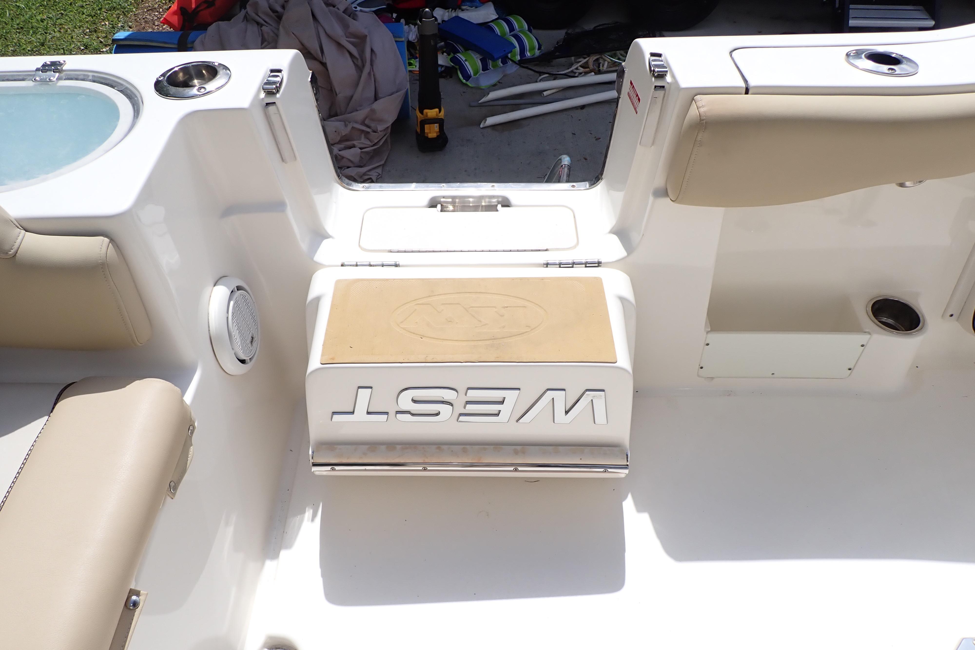 2019 Key West 263 FS boat interior with beige seating and storage compartments.