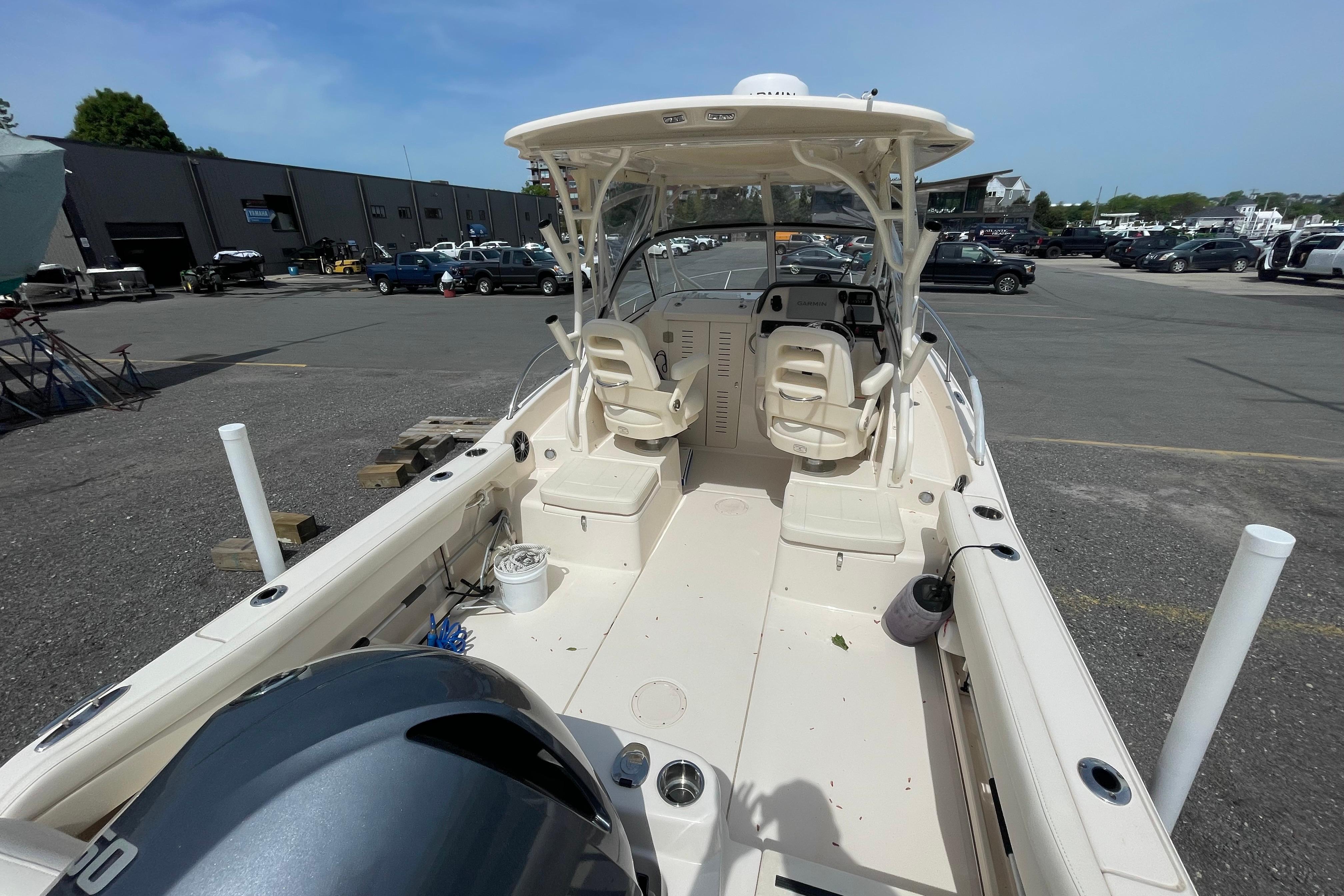 2024 Grady-White Adventure 218 boat with dual seating, parked in a marina lot.