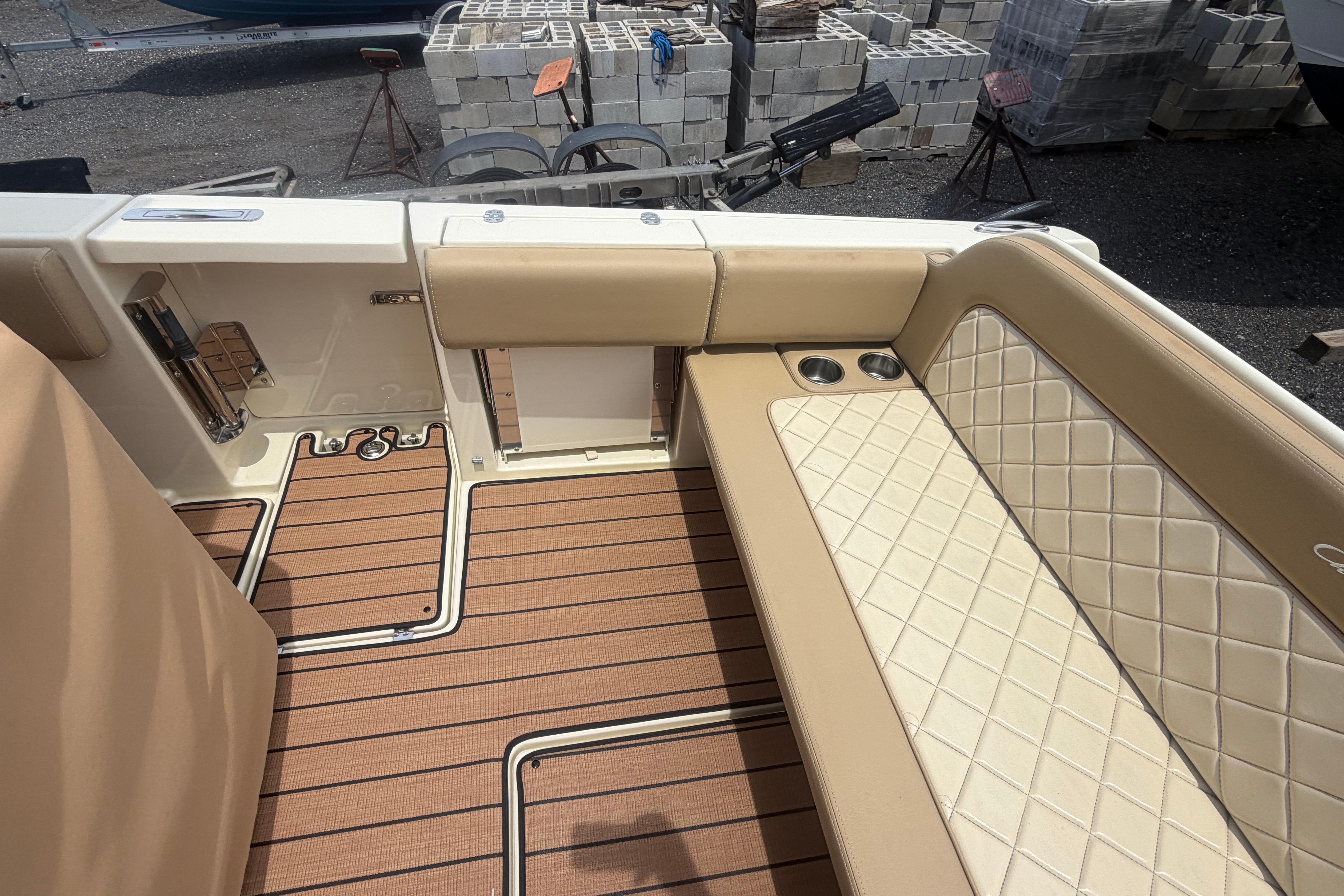 2017 Chris-Craft Catalina 34 interior with tan seating and wood-patterned flooring.