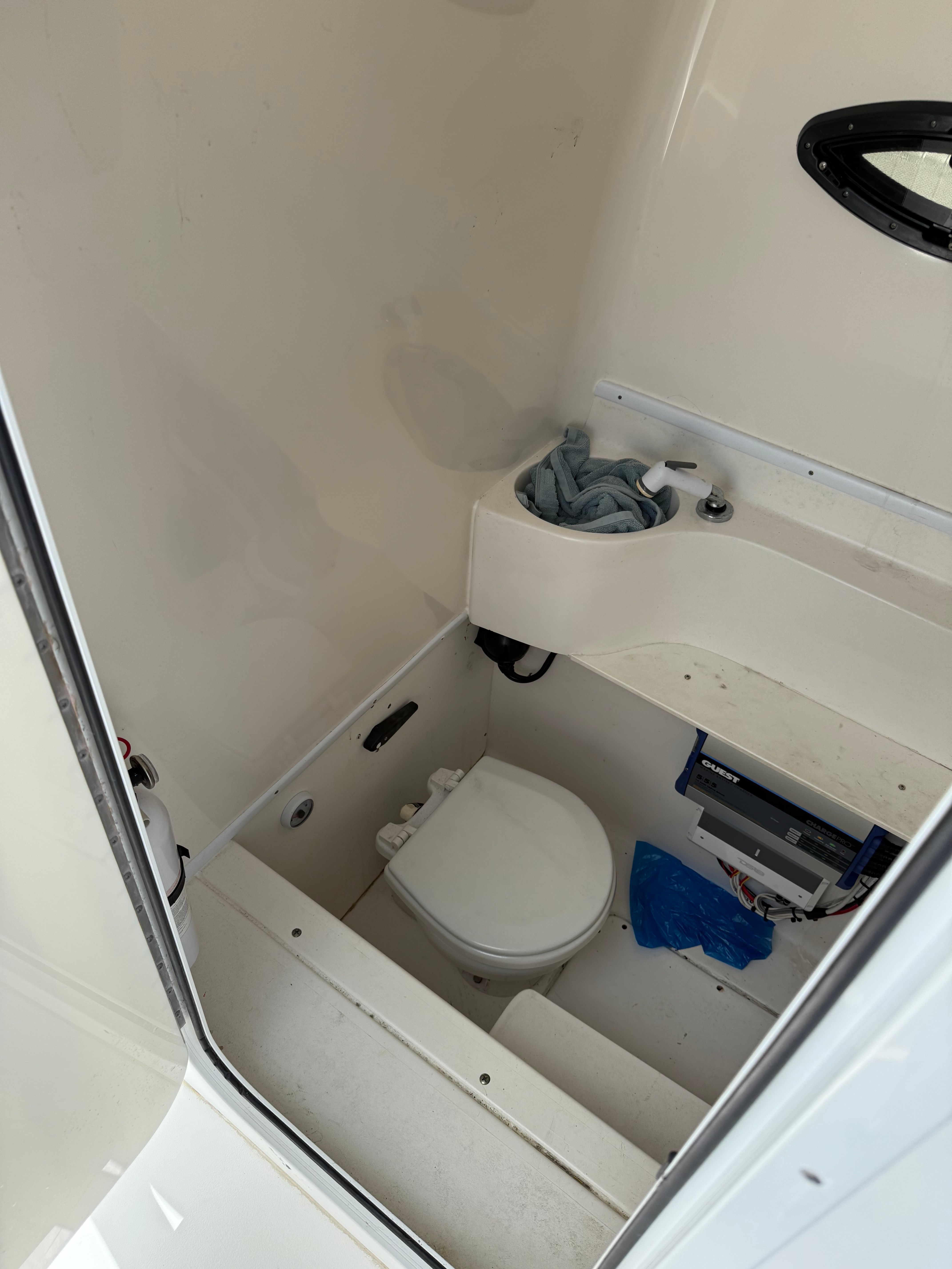 Interior of a 2012 Contender 32 ST with toilet and sink.