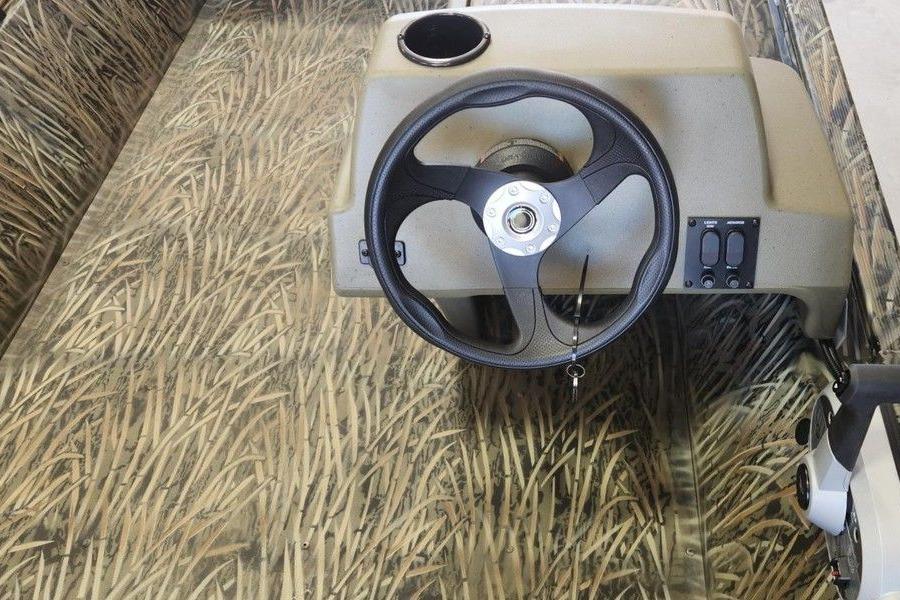 2026 Tracker Grizzly 1648 SC boat interior with camo design and steering wheel.