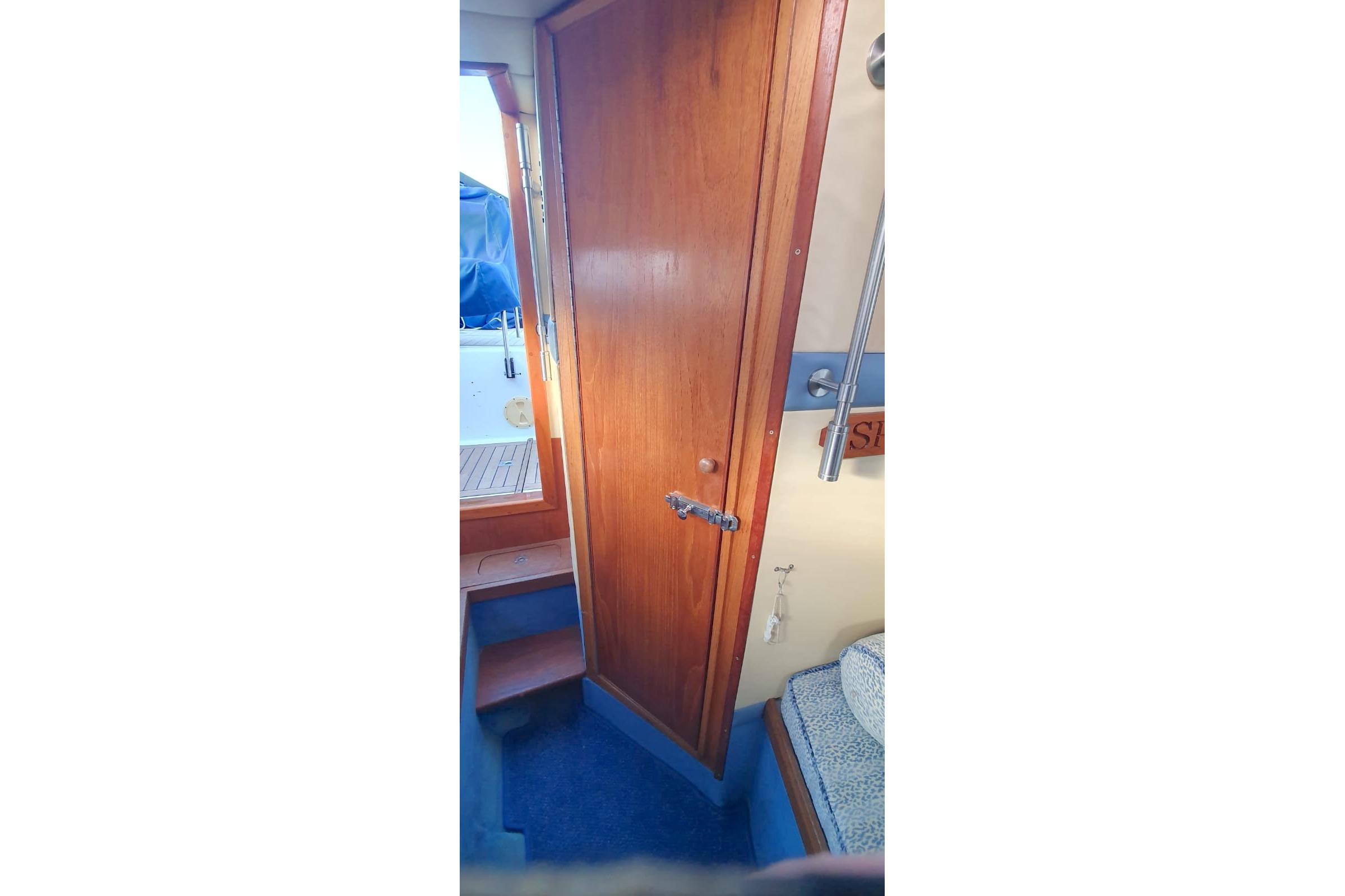 Interior view of 1989 Fairey Spearfish MKIII boat with wooden door and steps.