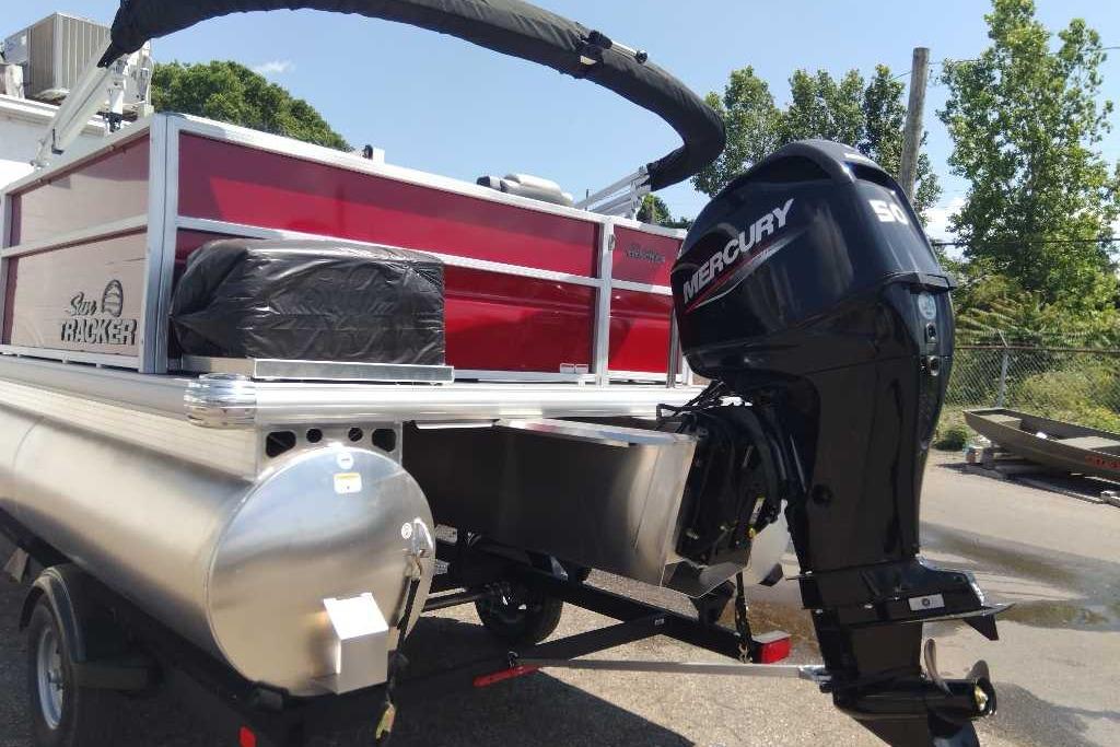 2026 Sun Tracker Party Barge 16 DLX with Mercury outboard motor, parked outdoors.