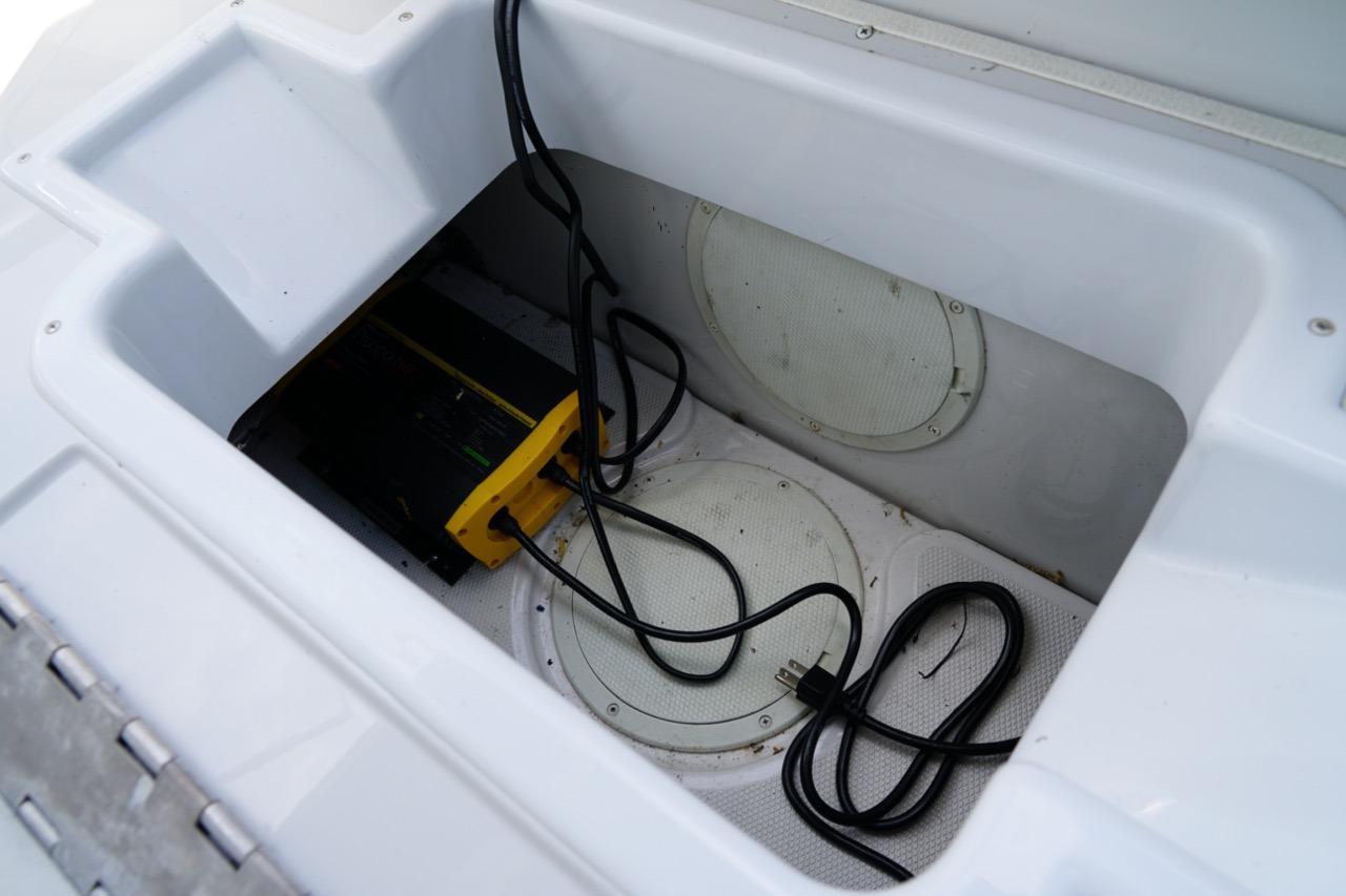 Storage compartment of a 2004 Crownline 216 LS boat with cables and equipment.