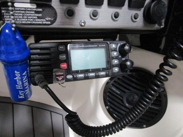Close-up of a 2017 Larson 292 LXI boat's control panel with radio and speaker.