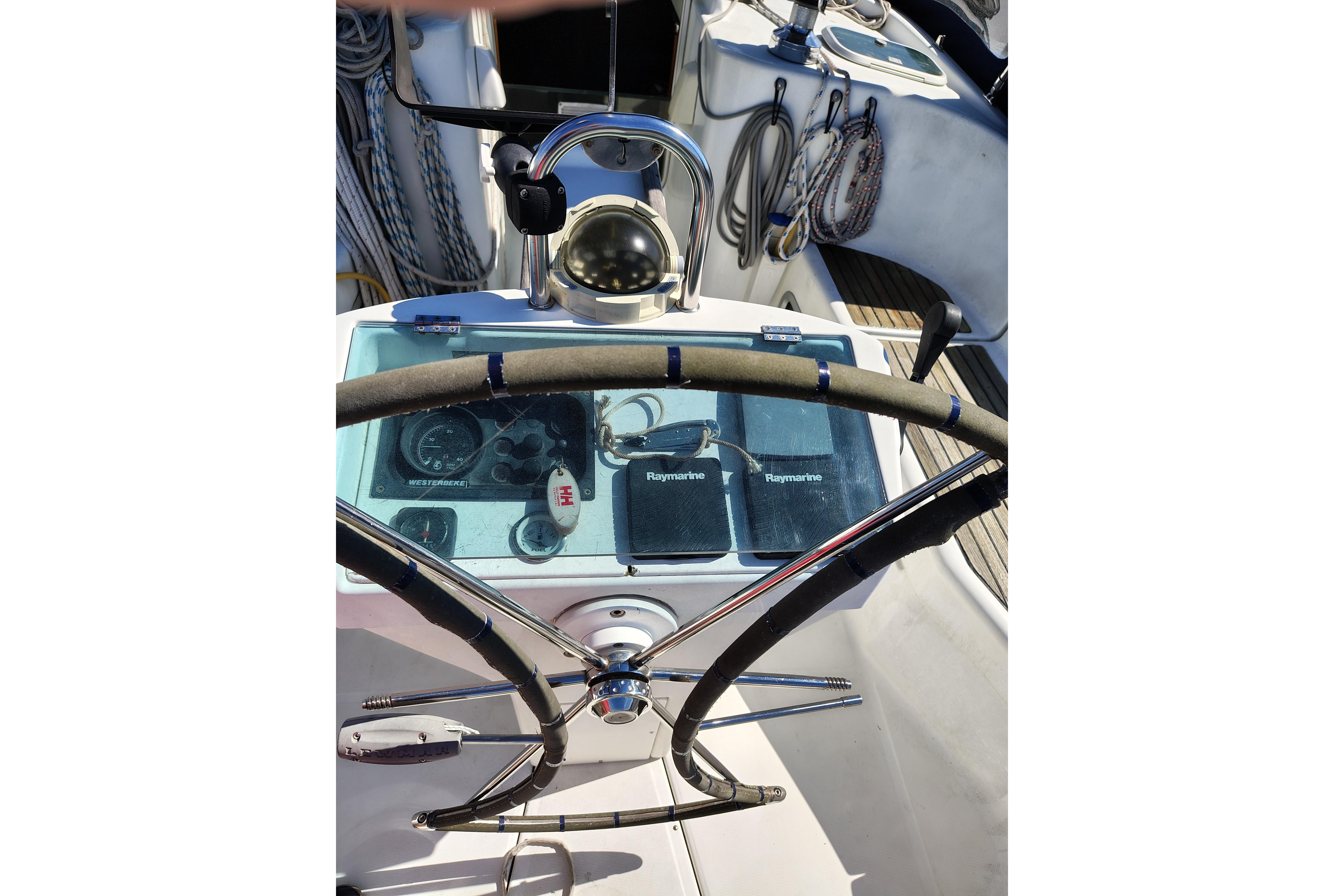 Steering wheel and controls of a 2001 Beneteau Oceanis 411 sailboat.