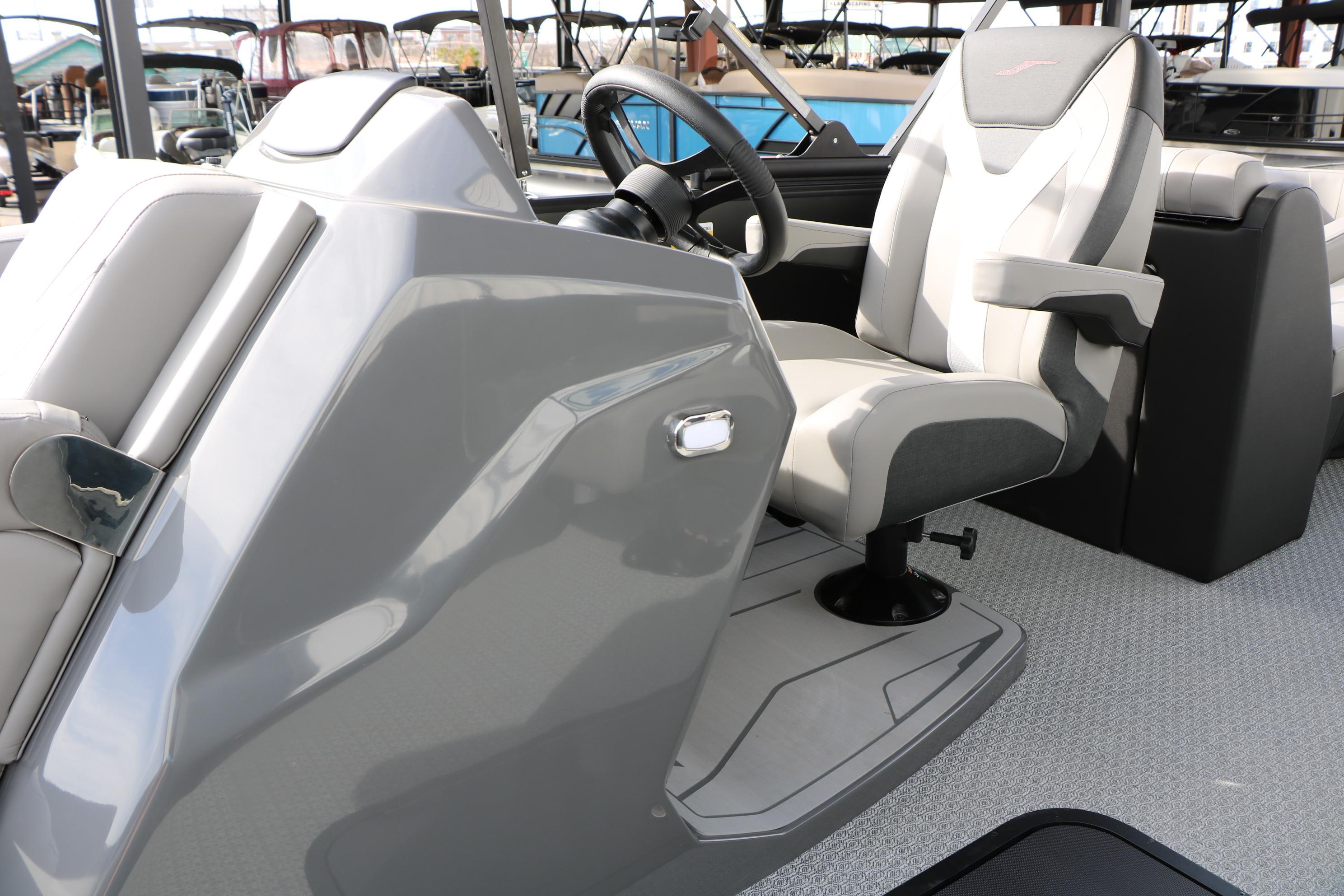Captain's seat and helm of 2026 Evotti 521QL boat, featuring sleek design and modern controls.