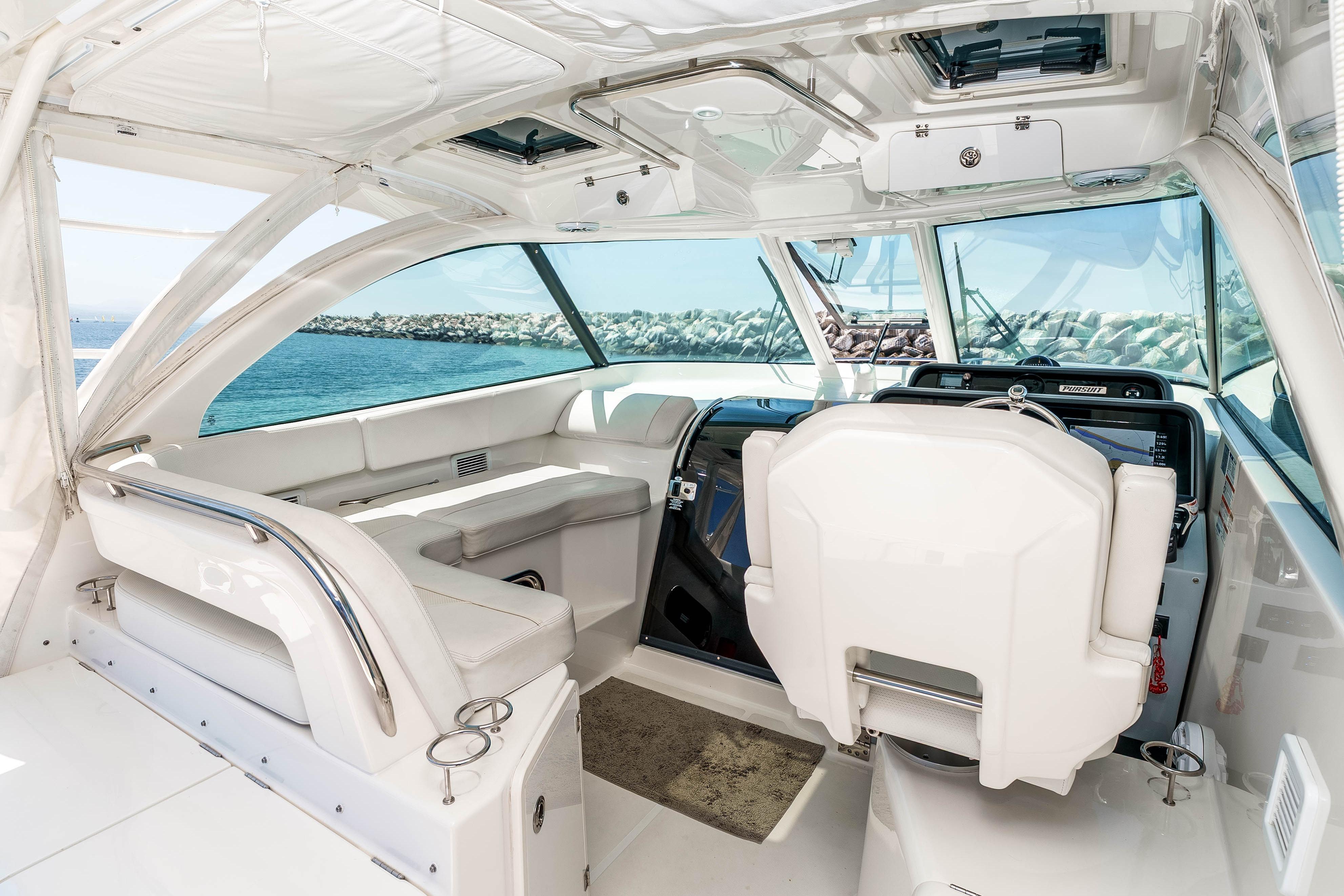 Luxurious interior of 2022 Pursuit OS 385 Offshore boat with modern helm and seating.
