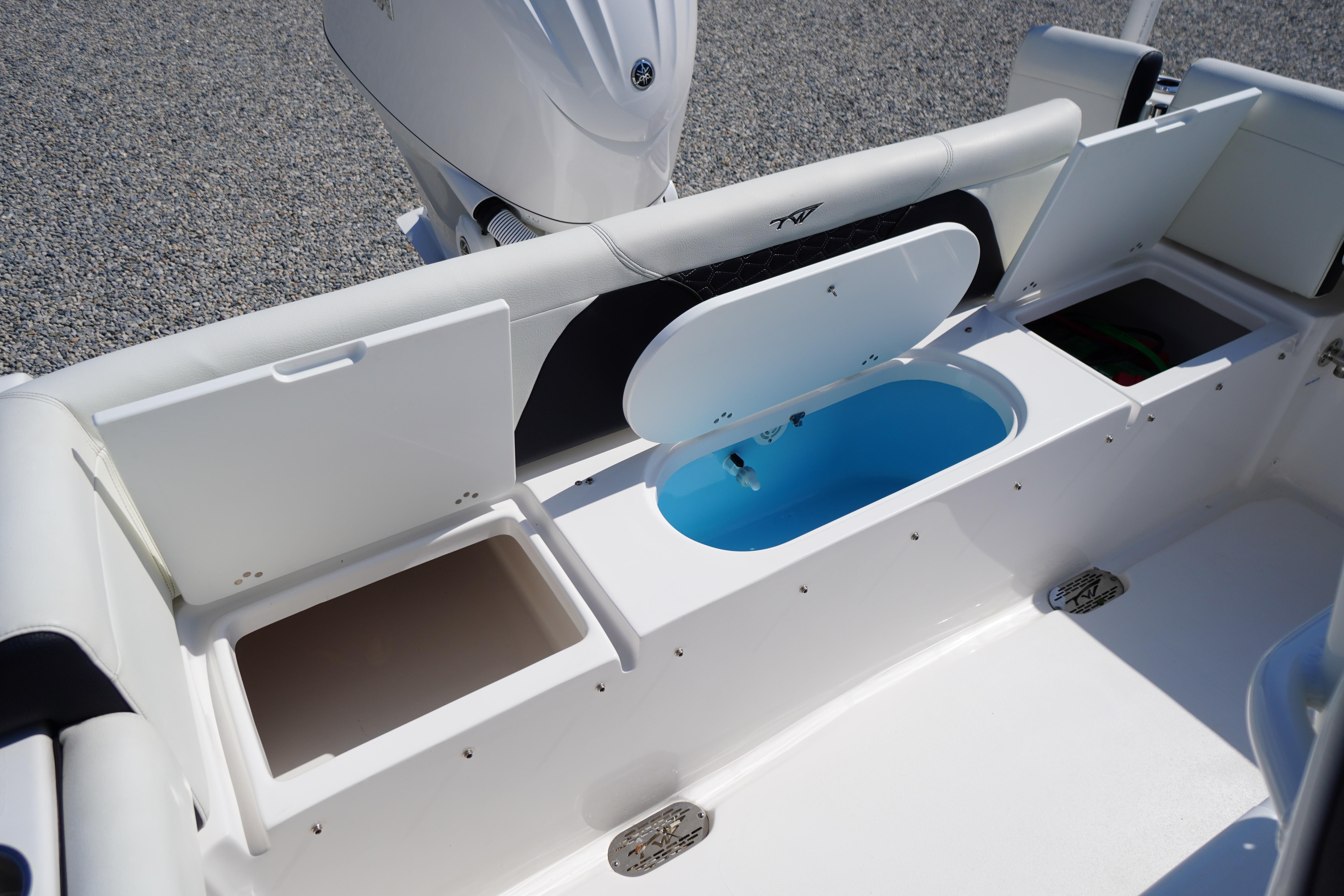 2025 Tidewater 232 SS boat interior with storage compartments and livewell.