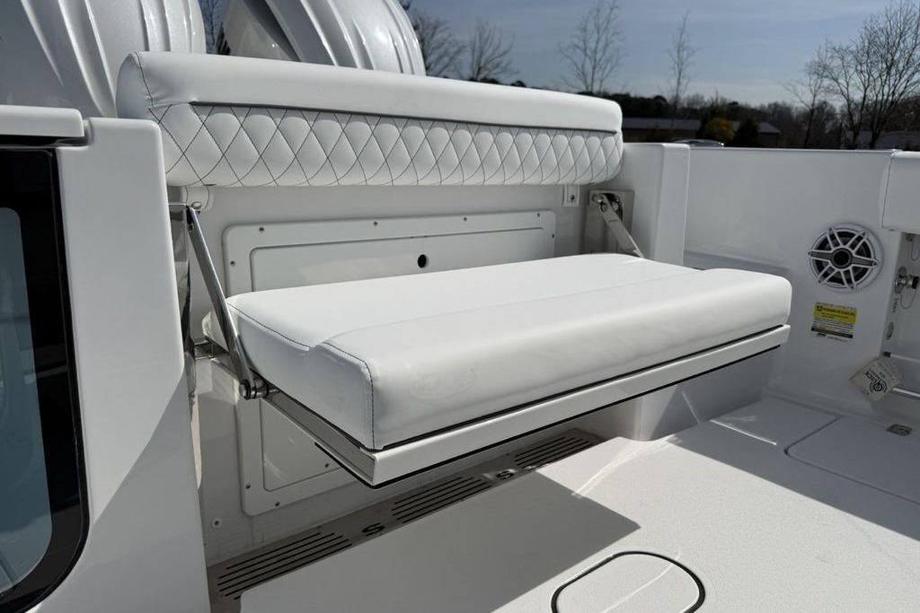 2026 Sportsman Open 252 Center Console boat with white cushioned seating.