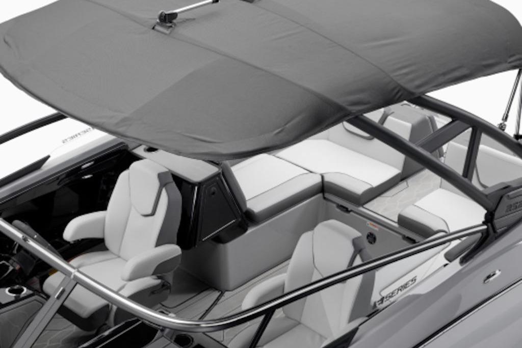 2025 Yamaha Boats 252XE interior with seating and canopy, showcasing modern design and comfort.