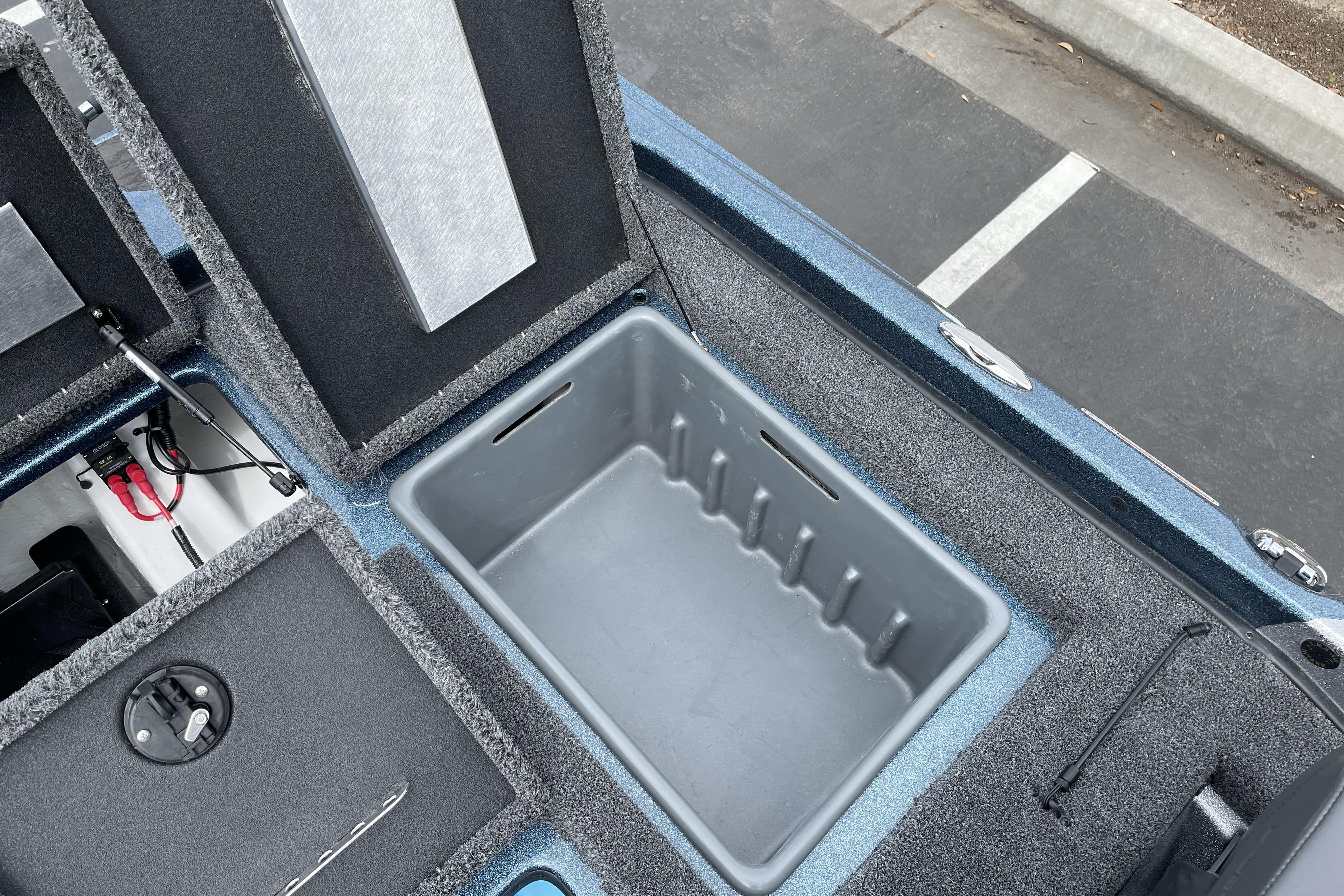 Open storage compartment in 2026 Nitro Z21 XL boat, showcasing interior design and features.