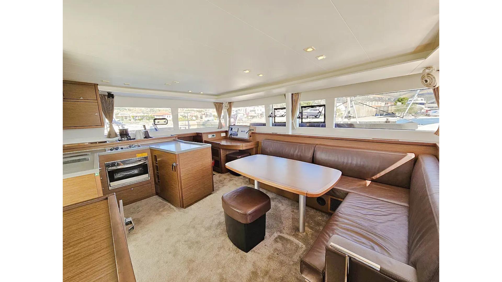Interior of 2018 Lagoon 450 F catamaran with modern kitchen and seating area.