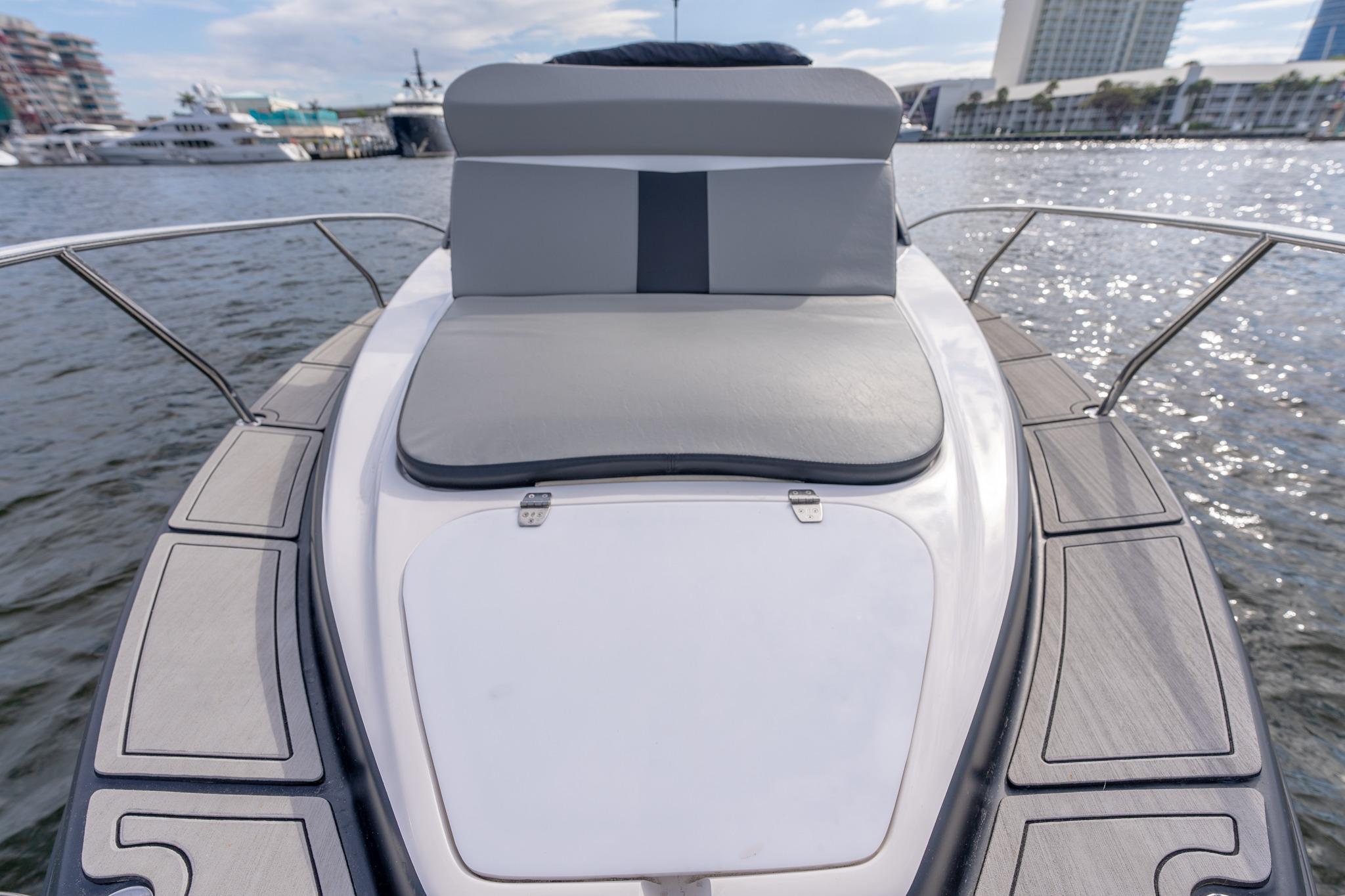 Luxurious Hanover 305 yacht deck with cushioned seating, docked in a marina, 2027 model.