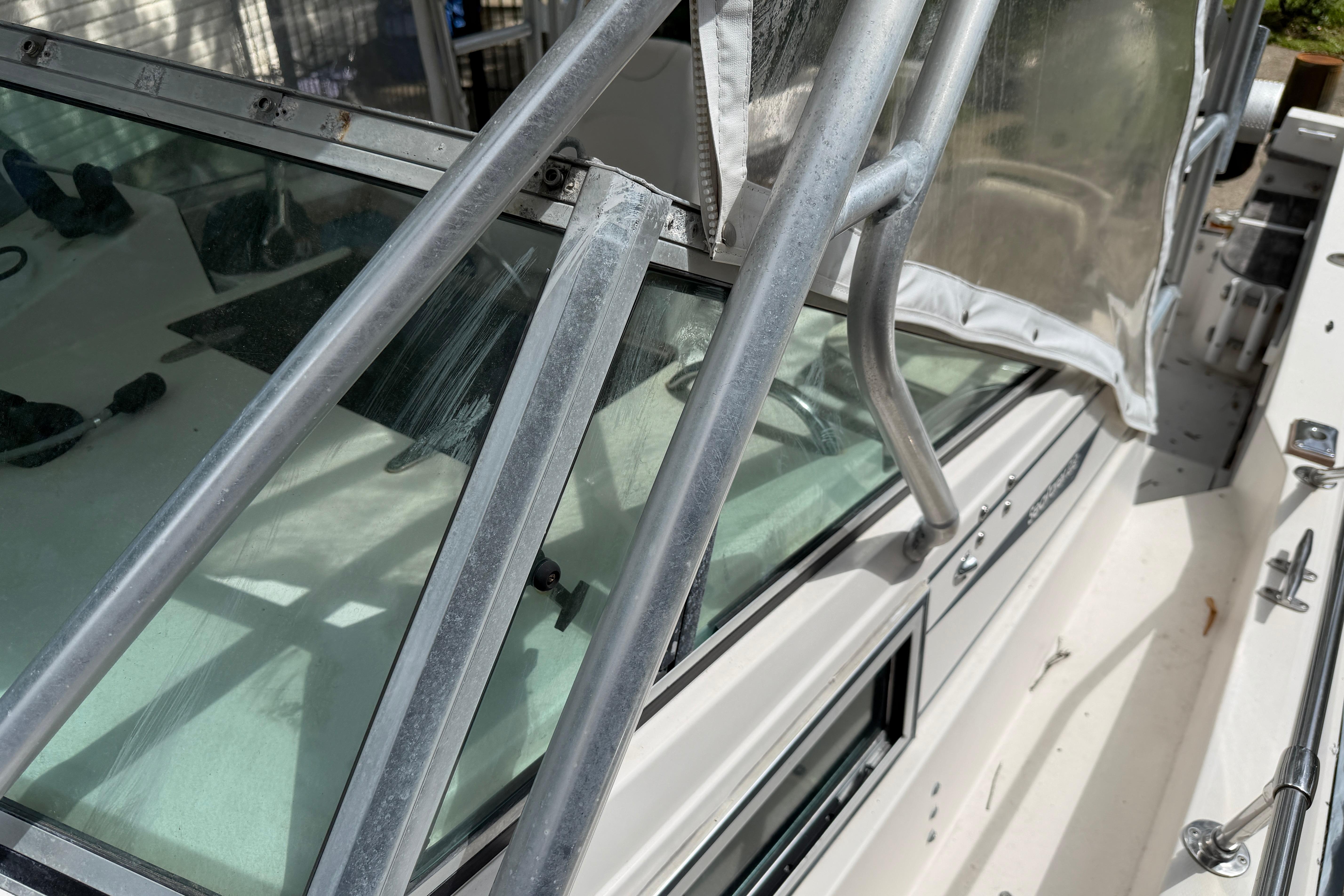 1987 Grady-White Seafarer 226 boat with metal railings and glass windows.