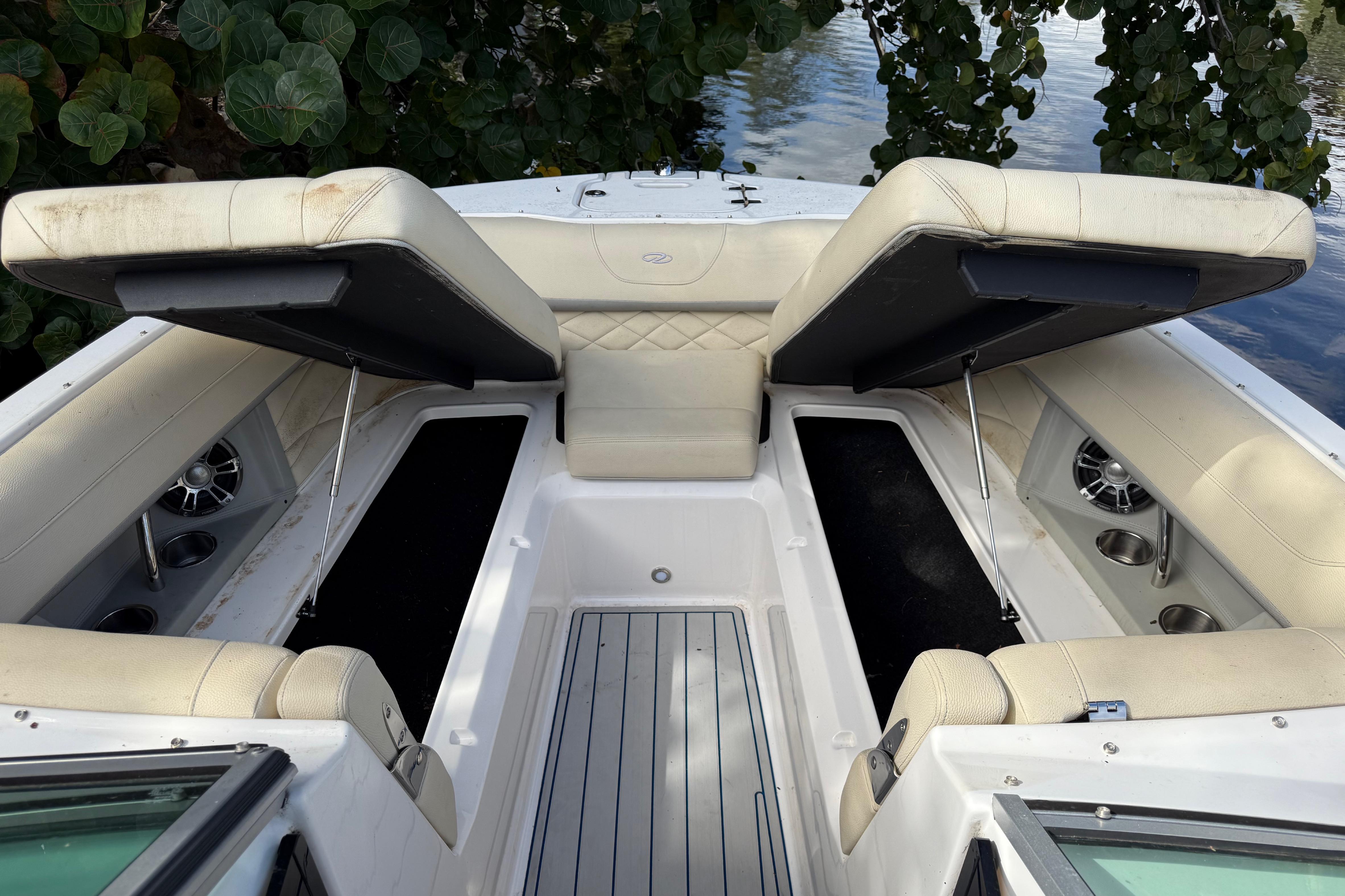 2021 Regal 26 OBX boat interior with open storage compartments and cushioned seating.