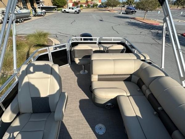 2024 Sun Tracker SportFish 22 DLX pontoon boat interior with beige seating and spacious layout.