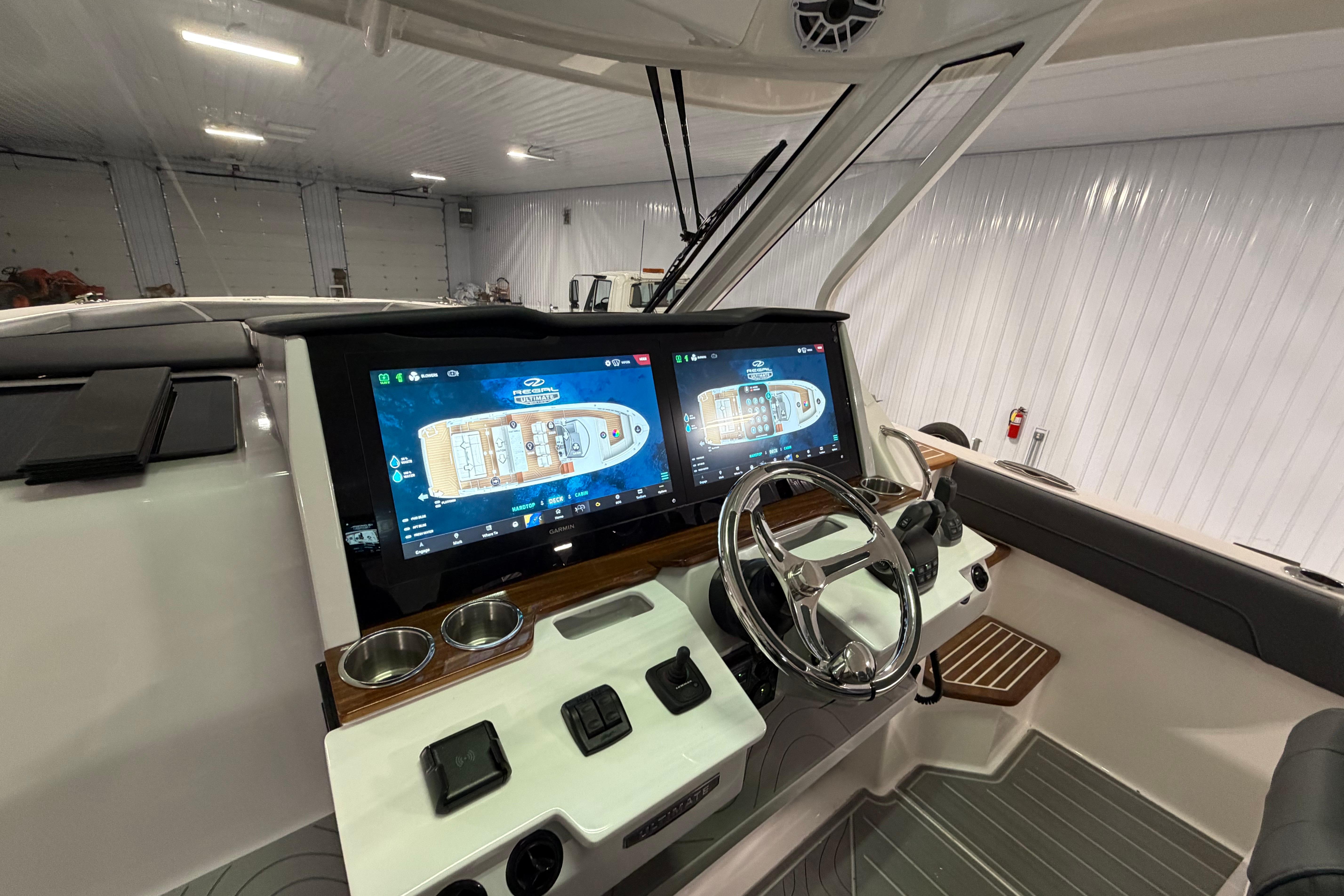 2027 Regal 38 Surf boat cockpit with dual touchscreen displays and modern steering wheel.
