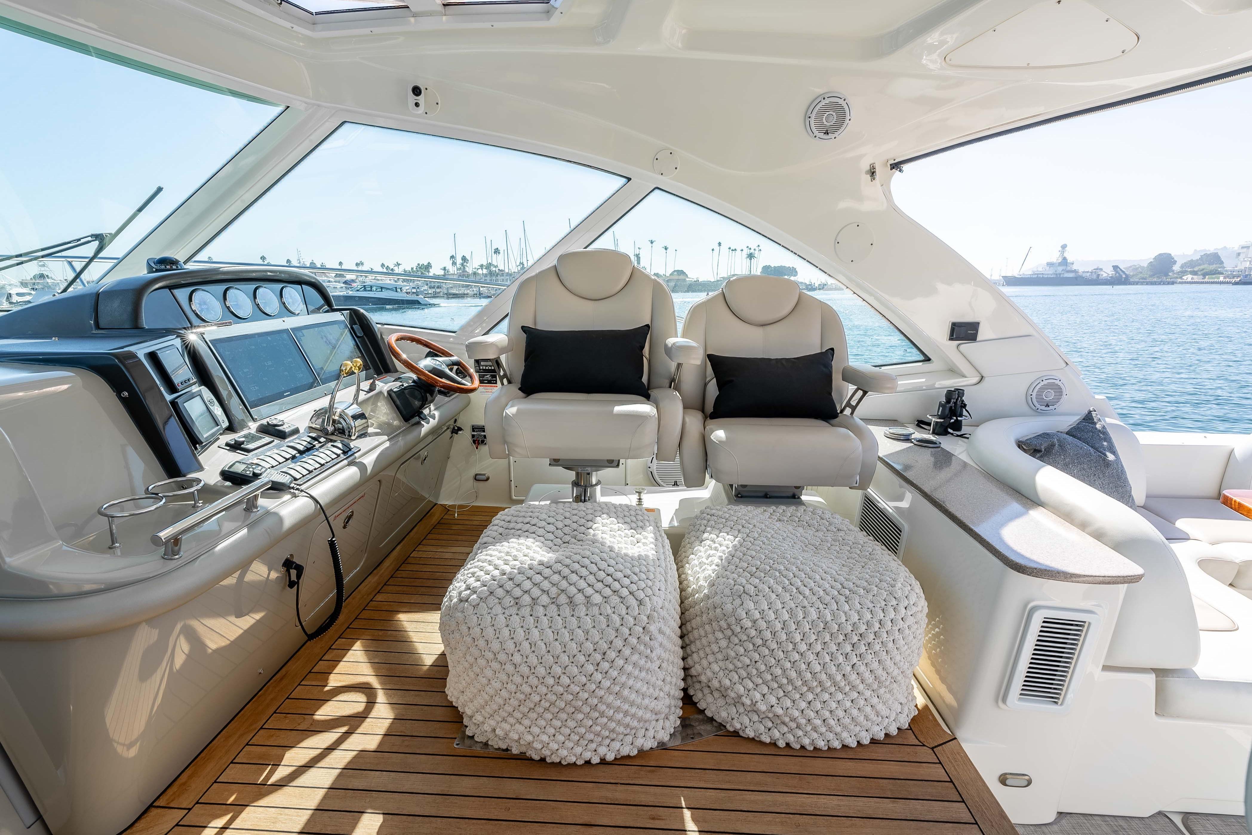 Luxurious 2007 Sea Ray 48 Sundancer yacht interior with plush seating and modern controls.