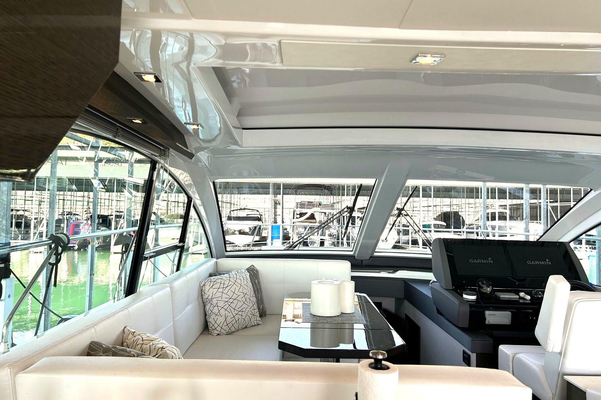 Luxurious interior of 2021 Cruisers Yachts 50 Cantius with modern seating and helm.