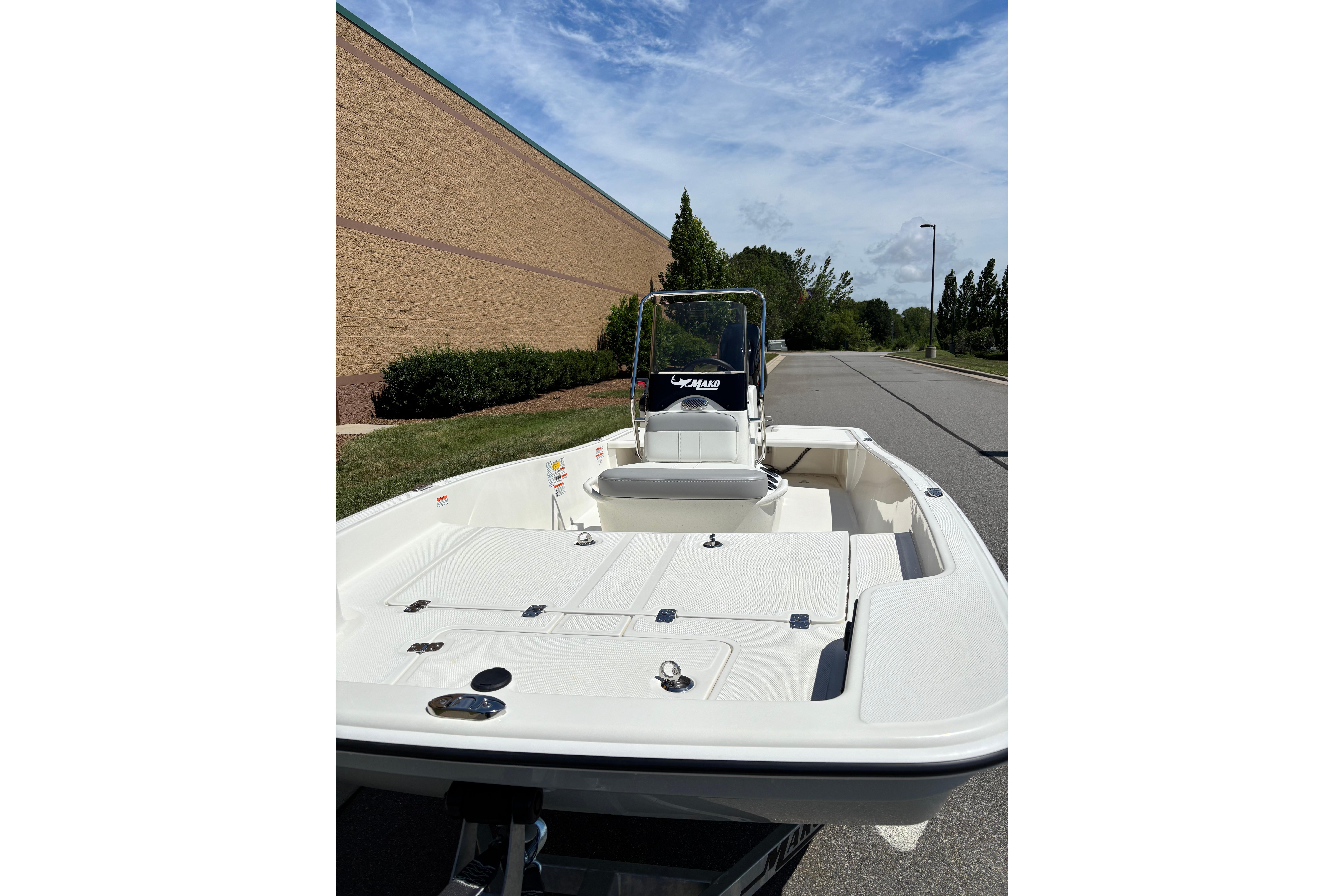 2026 Mako Pro Skiff 15 CC boat on a road, clear sky background.