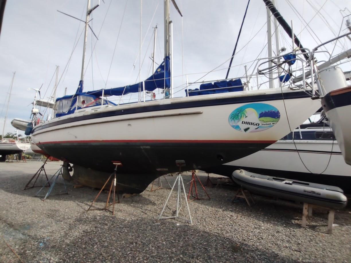 1981 Bruce Roberts 450 sailboat on stands, featuring blue accents and a tropical-themed logo.