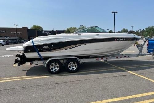 2006 Chaparral 220 SSi boat on trailer in parking lot, side view.