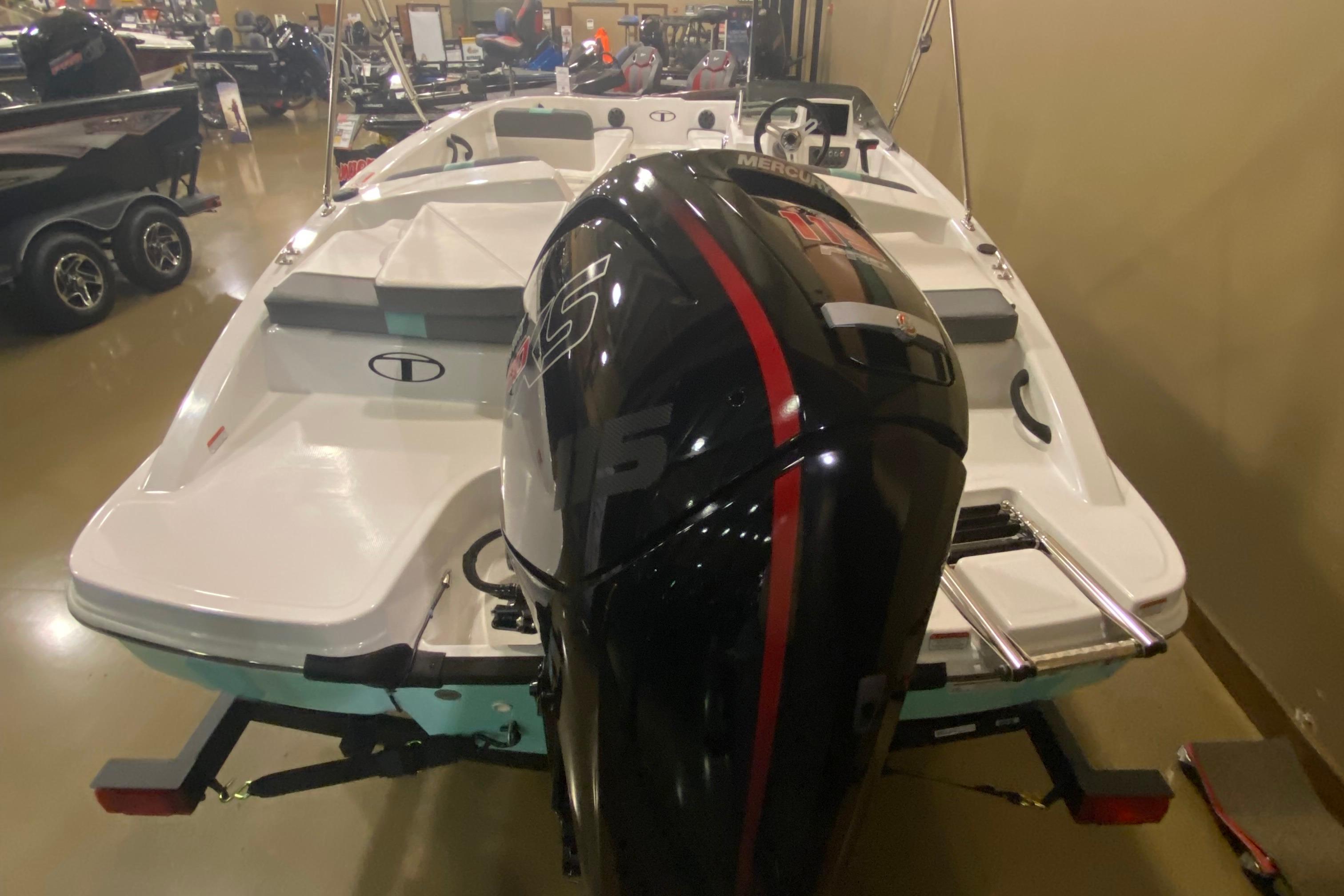 2026 Tahoe T18 boat with powerful Mercury outboard motor displayed indoors.